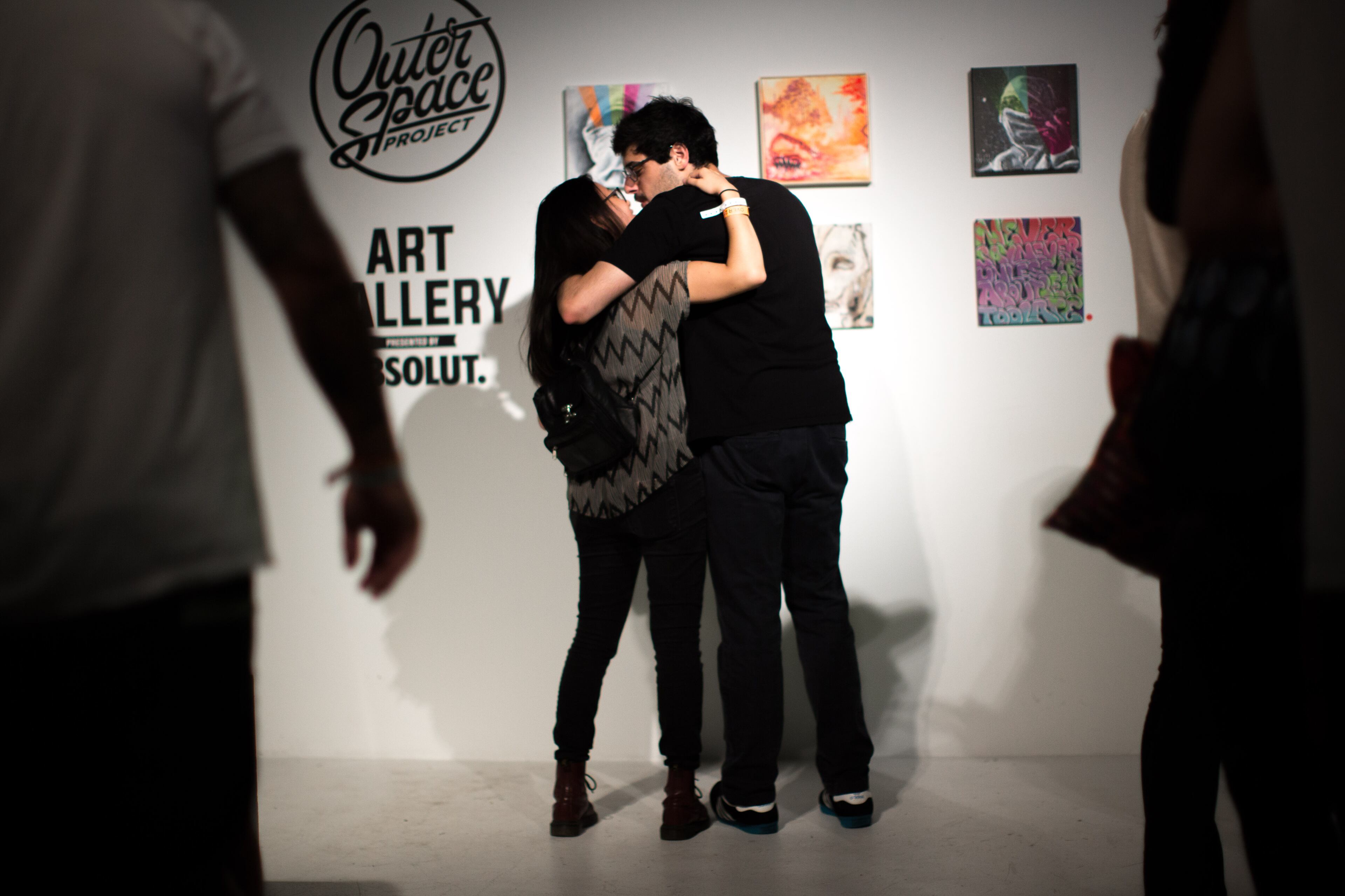 Kristy Cho, left, and Guga Gogia embrace in front of an art installation at The Big Bang: The Outer Space Project Block Party at Terminal West, Saturday, June 27, 2015, in Atlanta. BRANDEN CAMP/SPECIAL