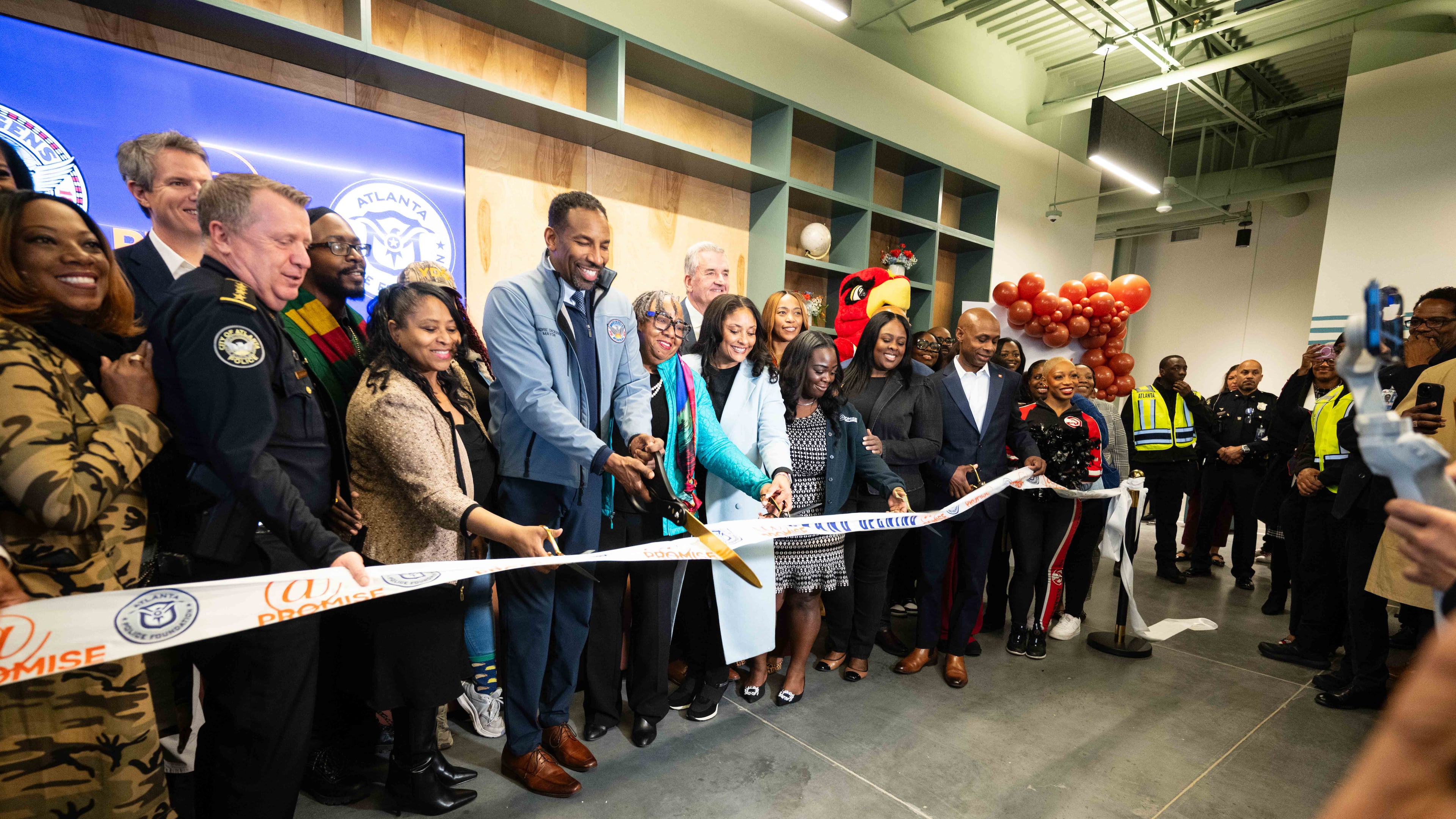 City and community leaders, including Atlanta Mayor Andre Dickens, cut the ribbon at the grand opening of the city's fourth At-Promise center Friday Jan. 23, 2026. The centers were created to give teens and young adults opportunities to get off the streets and explore other outlets and careers. (Lloyd Mackayi/Courtesy of Atlanta Police Foundation)