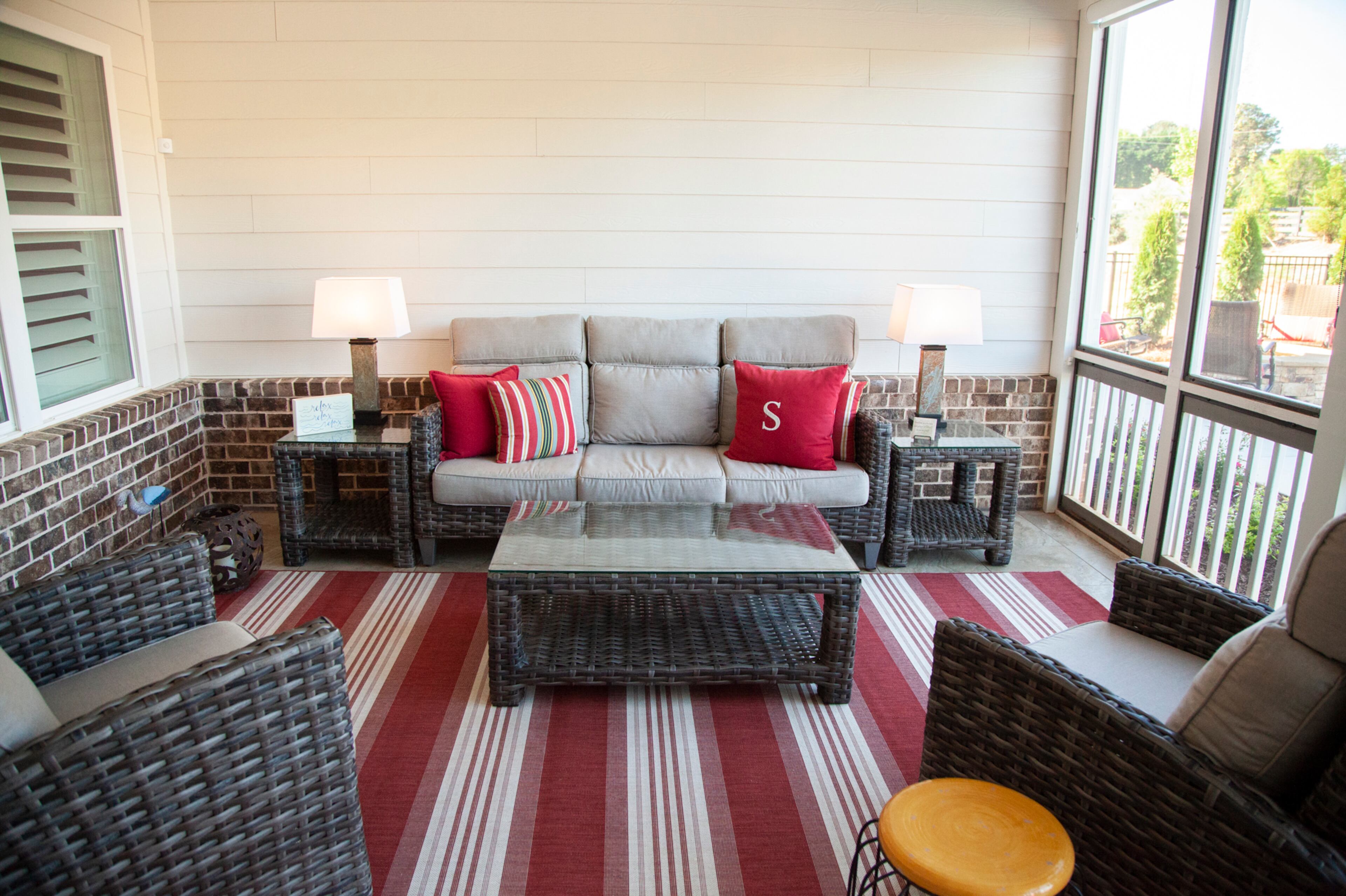 Overlooking the pool, the screened-in porch has furniture from Georgia Patio and a rug from Target.