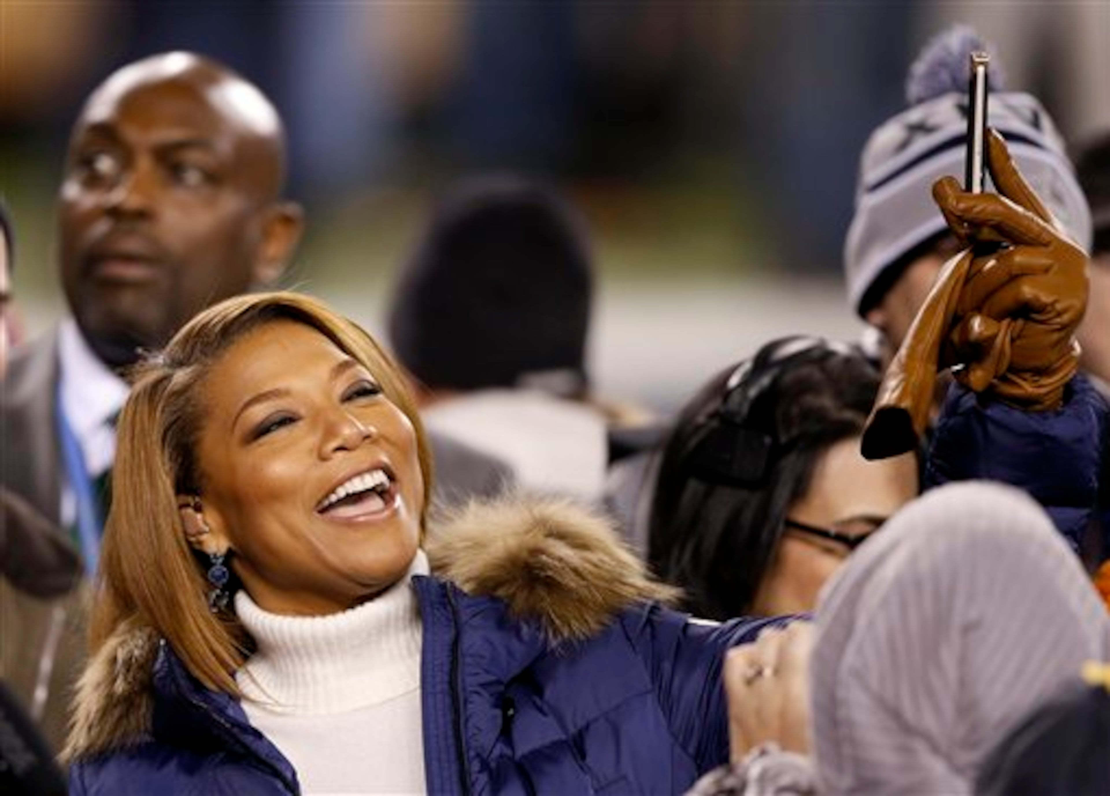 Queen Latifah arrives on the field before the NFL Super Bowl XLVIII football game between the Seattle Seahawks and the Denver Broncos Sunday, Feb. 2, 2014, in East Rutherford, N.J. (AP Photo/Kathy Willens)