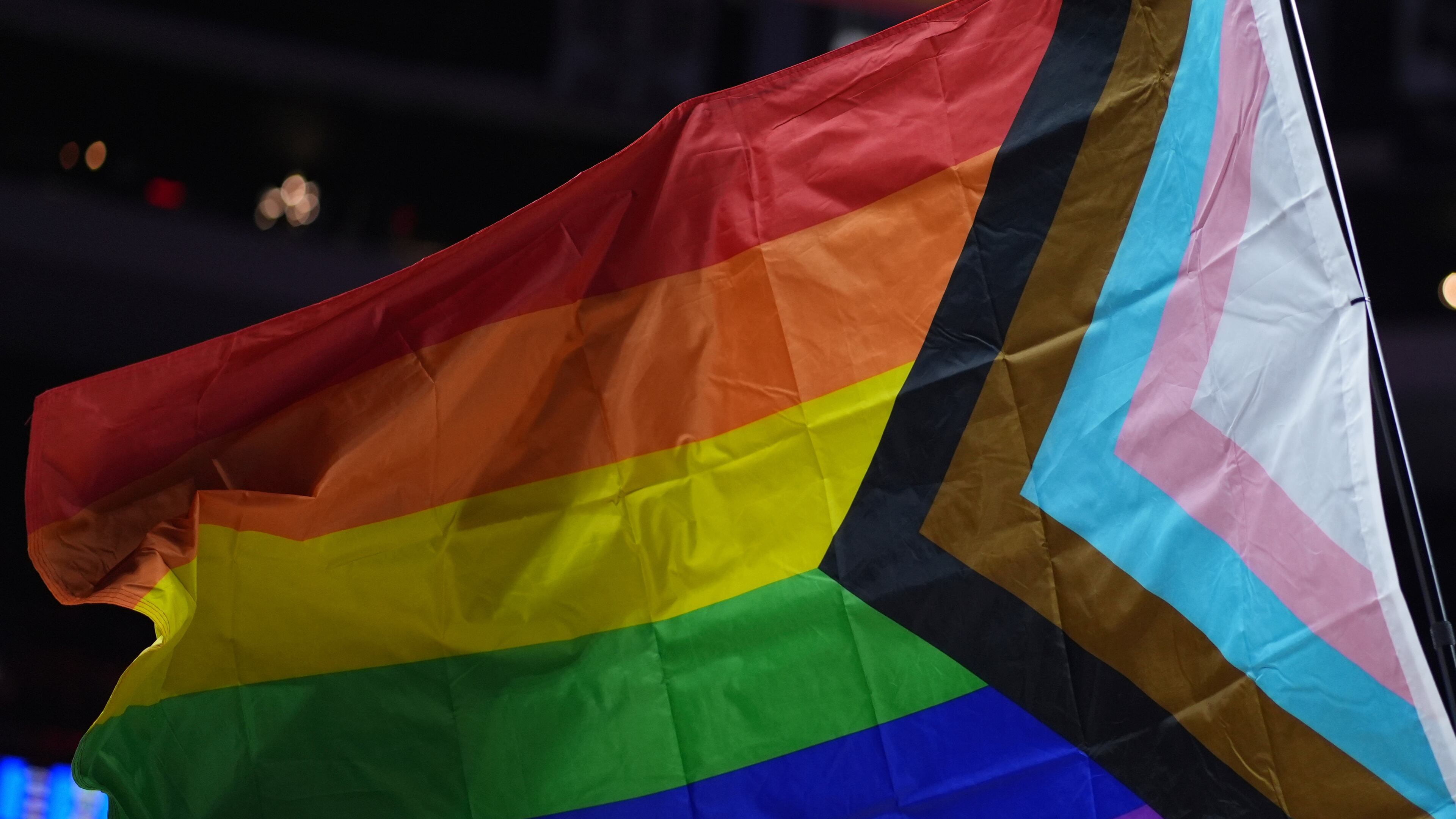 FILE - A pride flag is waved during an NBA basketball game in Philadelphia on Sunday, March 30, 2025. (AP Photo/Matt Slocum, File)