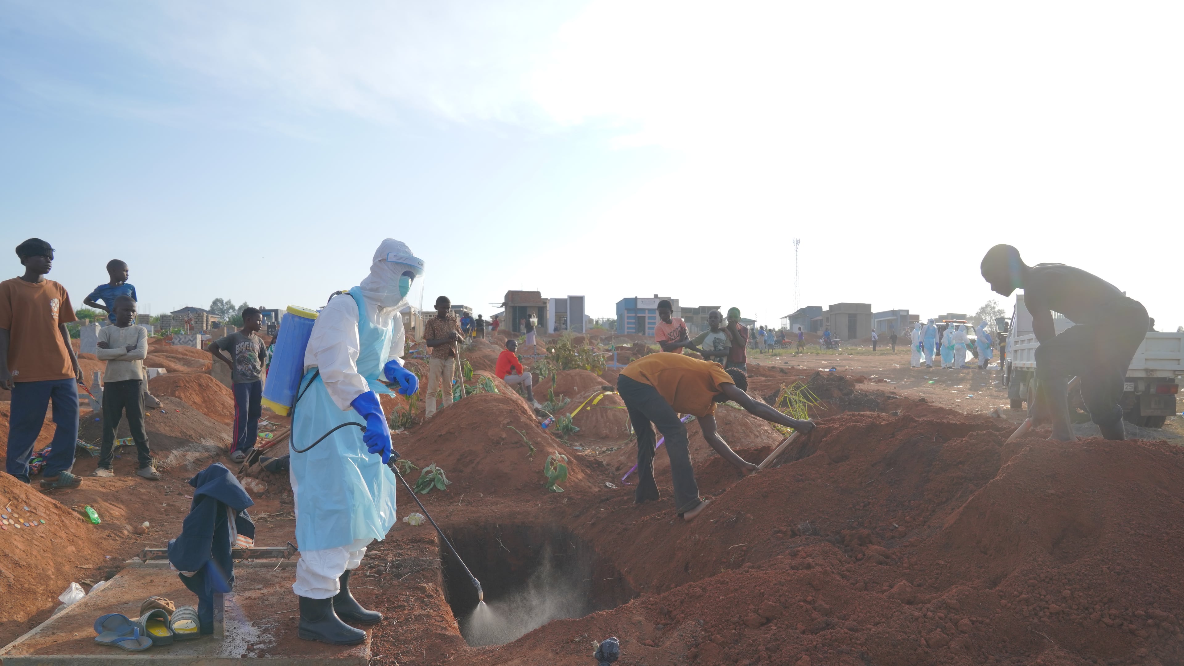A health worker sprays disinfectant in a freshly dug grave for the body of Jacques Lobo Dhena, who died of Ebola, in Bunia, Ituri province, eastern Congo, Wednesday, Aug. 12, 2026. (AP Photo/Dieudonne Dirole)