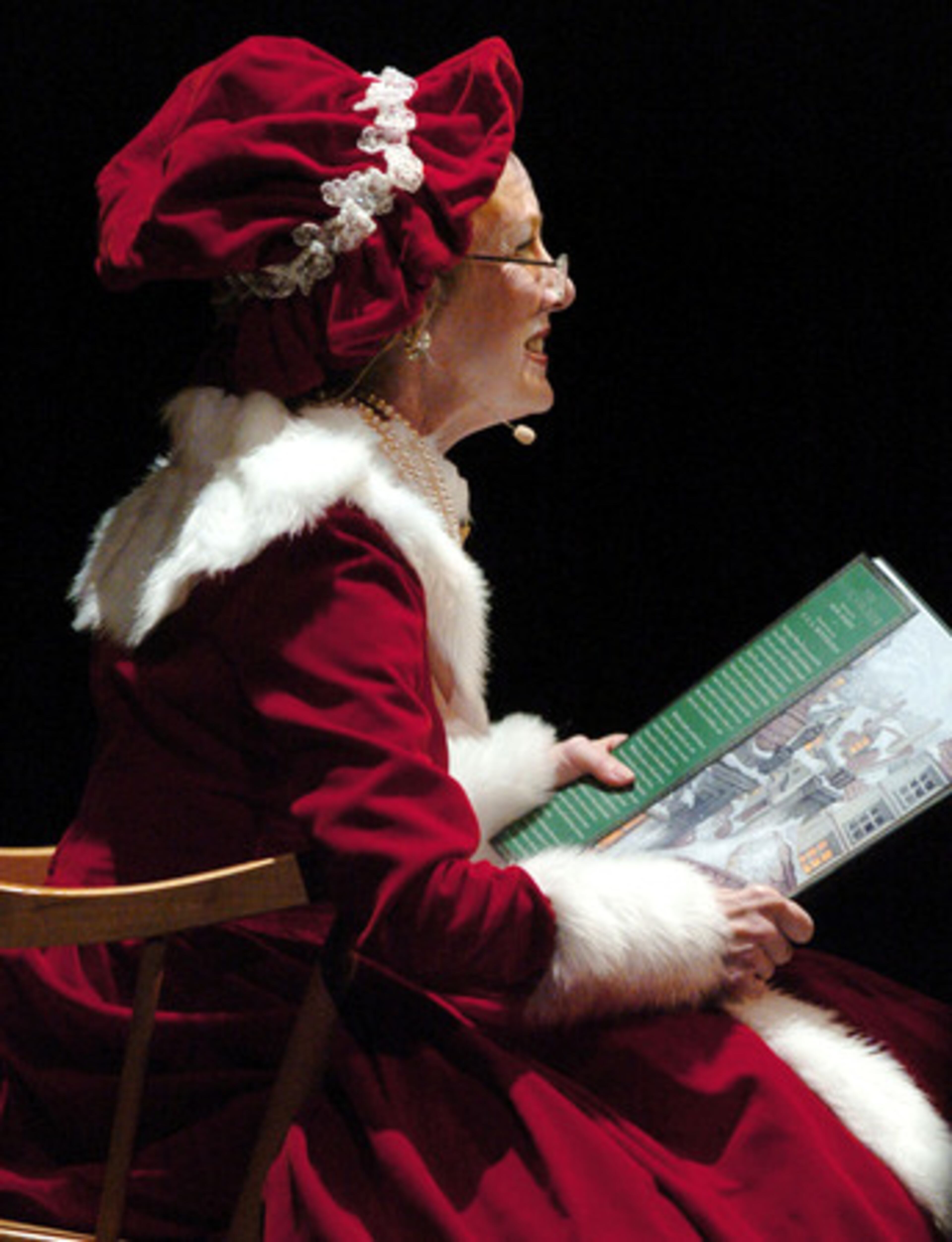 Barbara Hancock-Elrod reads The Nutcracker story to school children in the audience before Georgia Ballet dancers go on stage.