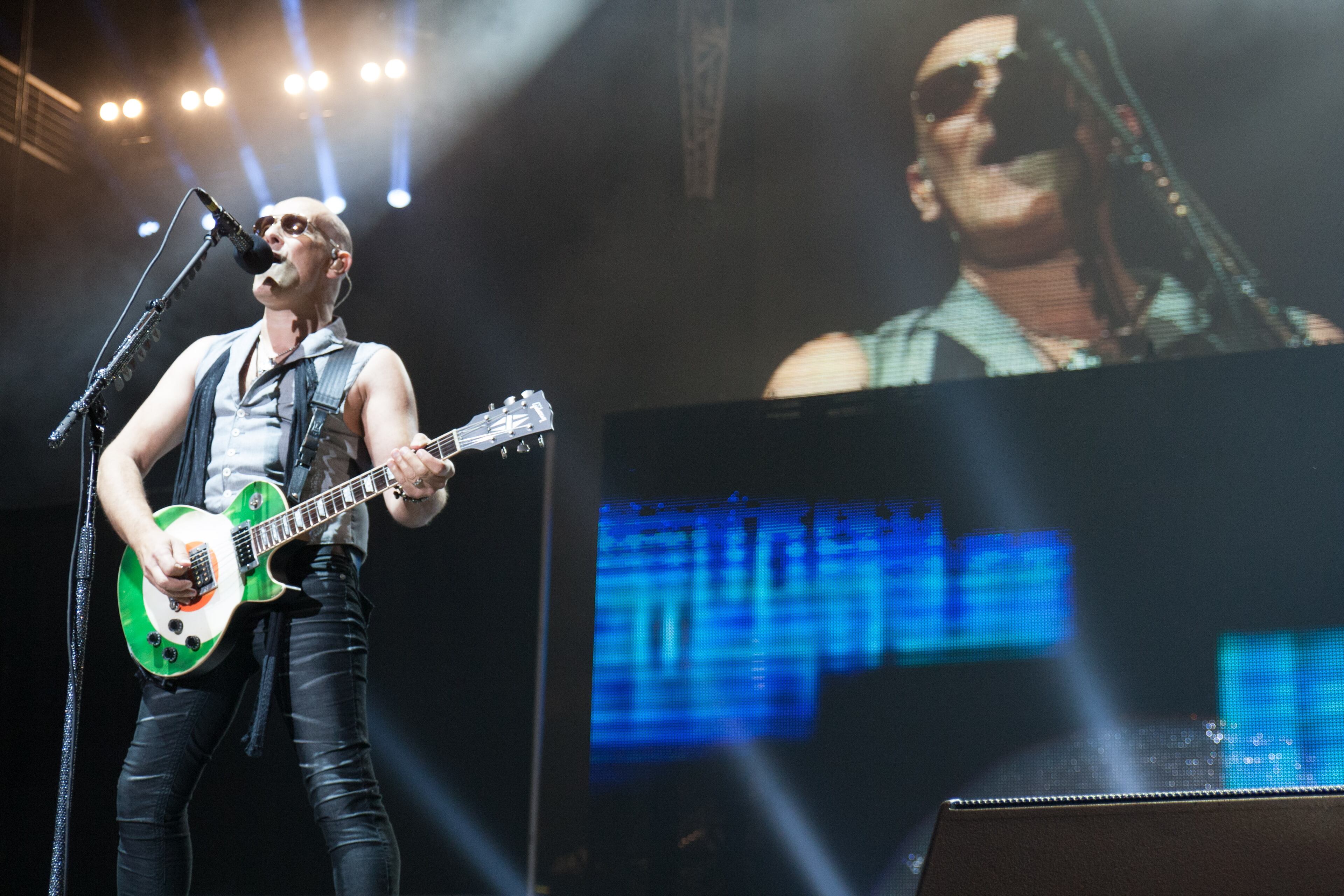Def Leppard guitarist Vivian Campbell performs at Aaron's Amphitheatre at Lakewood Friday, July 18, 2014 in Atlanta, Ga. KISS and Def Leppard made a stop in Atlanta during their 42-city North American tour.