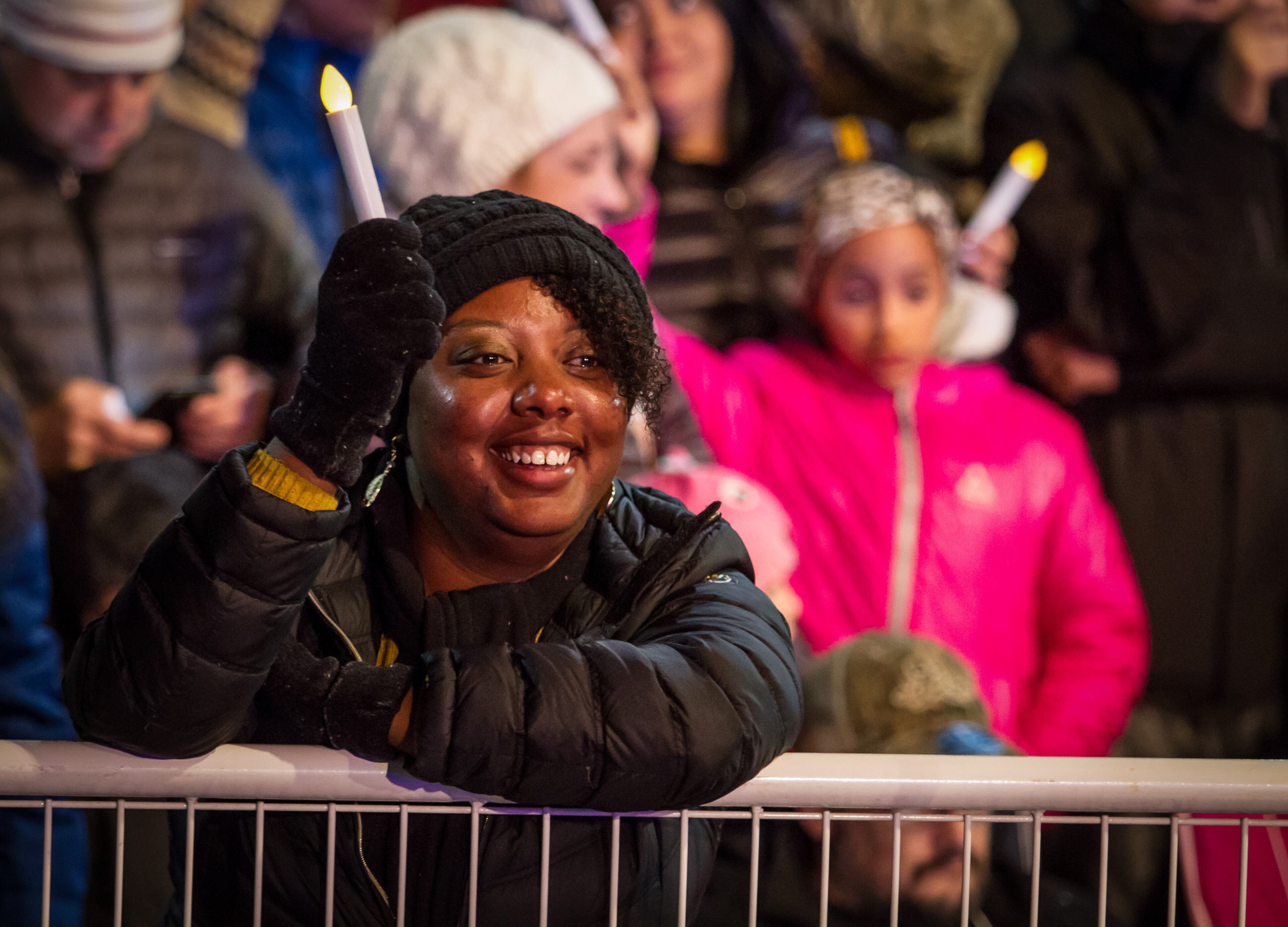 A woman holds up a battery candle while a rendition of O Holy Night is sung, right before the lighting of the Christmas tree during the Macy's 69th Annual Great Tree Lighting at Lenox Square Mall, Sunday, November 20, 2016, in Atlanta, GA. STEVE SCHAEFER / SPECIAL TO THE AJC