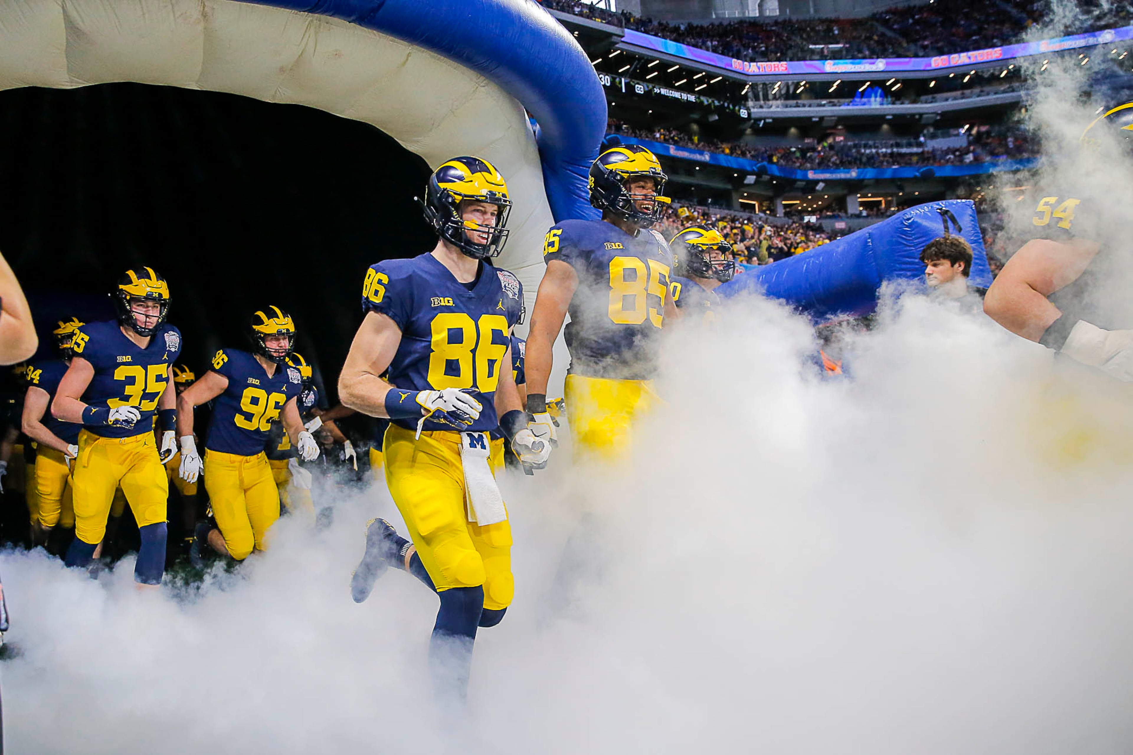 12/29/2018 -- Atlanta, Georgia -- The Michigan Wolverines enter the field before the start of the Chick-fil-A Peach Bowl at Mercedes-Benz Stadium in Atlanta, Saturday, December 29, 2018. (ALYSSA POINTER/ALYSSA.POINTER@AJC.COM)