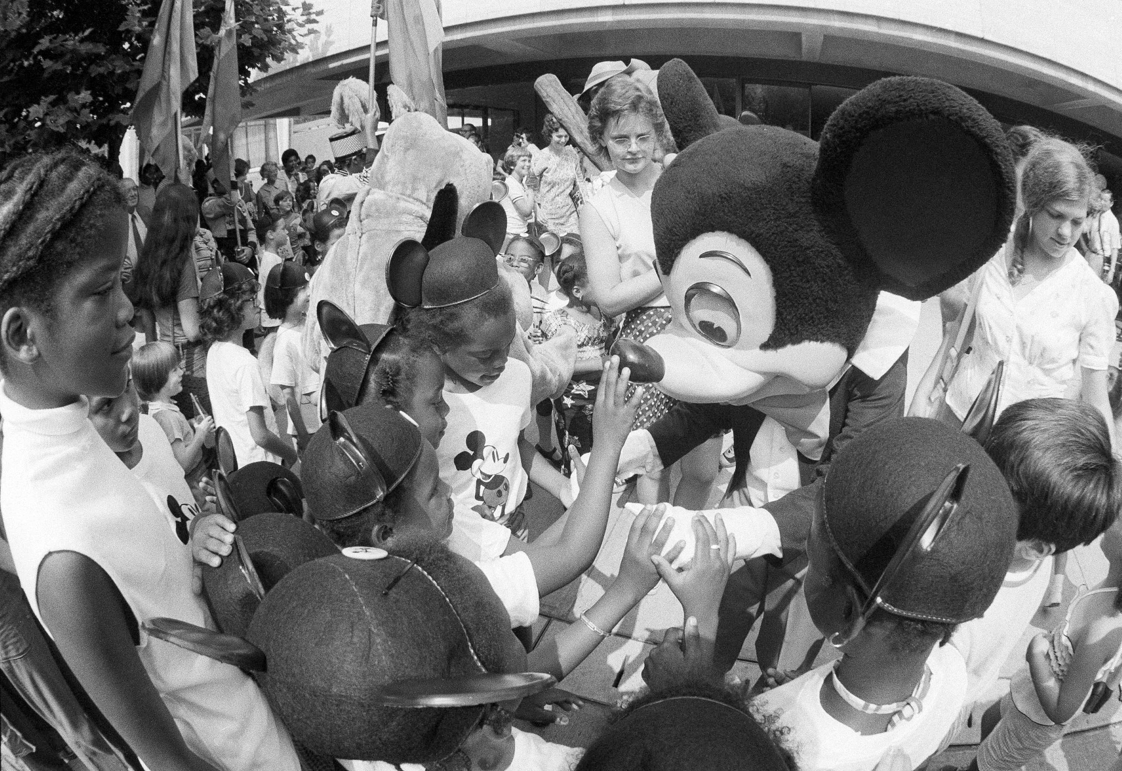 Mickey Mouse welcomes children to the opening of a month long Walt Disney 50th anniversary film retrospective being held on July 9, 1973 in New York at Lincoln Center in Alice Tully Hall. The first film presented was "Alice in Wonderland" which has not been shown in New York in 20 years. Each child attending the show received Mickey Mouse ears. (AP Photo)