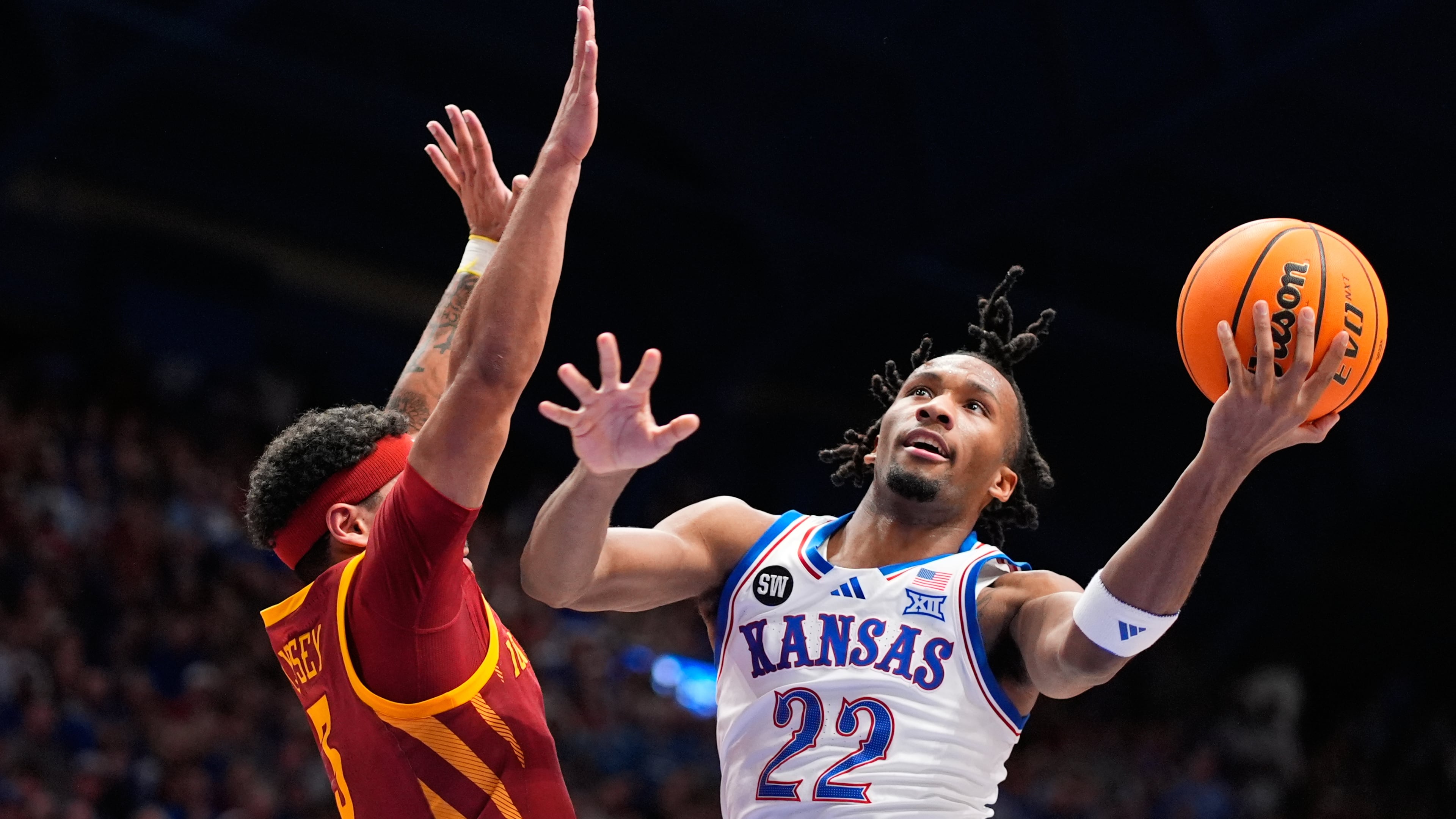 Kansas guard Darryn Peterson (22) shoots over Iowa State forward Joshua Jefferson (5) during the first half of an NCAA college basketball game Tuesday, Jan. 13, 2026, in Lawrence, Kan. (AP Photo/Charlie Riedel)