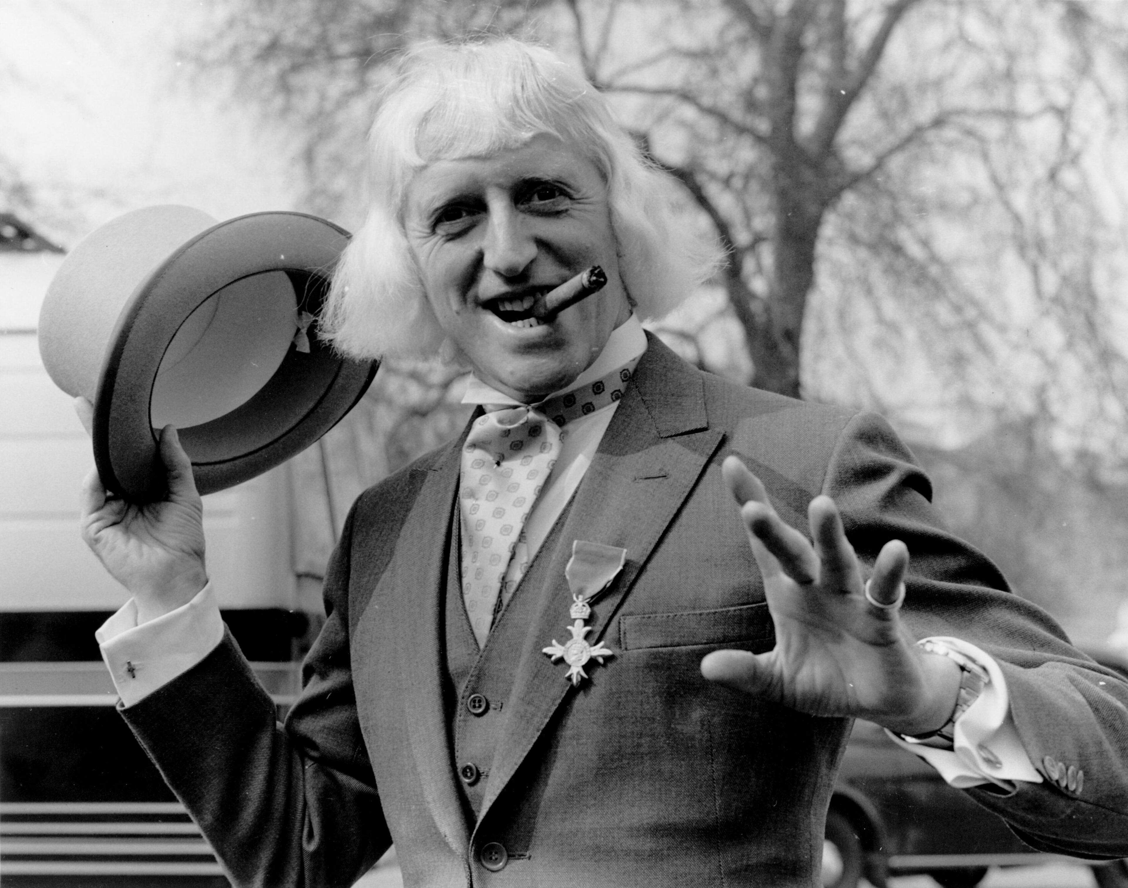 British radio disc jockey, television broadcaster and charity fundraiser Sir Jimmy Savile (1926-2011) sports his OBE after his investiture at Buckingham Palace, London, in 1972.