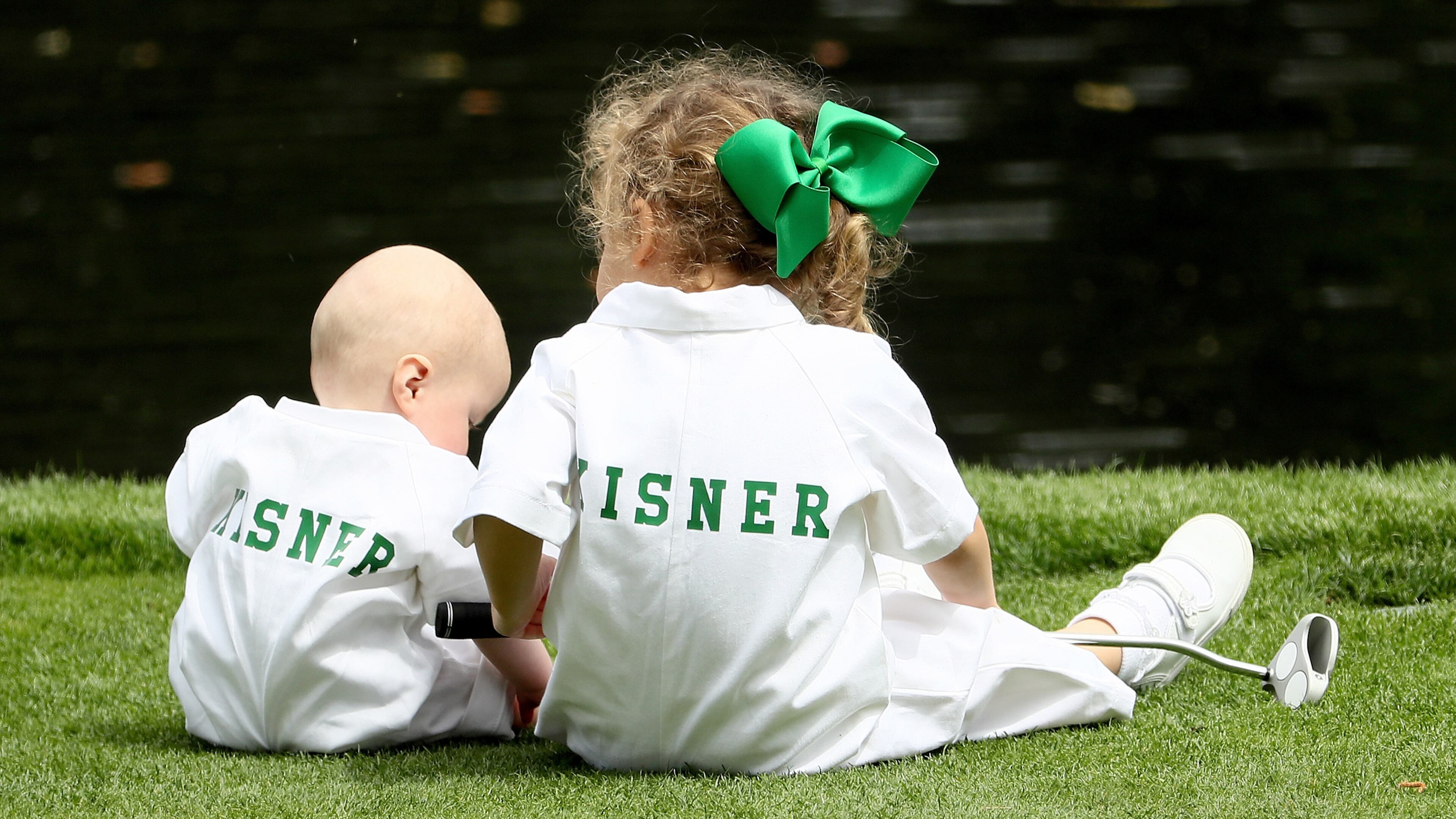 Henry Kisner and Kathleen Kisner, children of Kevin Kisner of the University of Georgia, sit together during the Par 3 Contest prior to the start of the 2018 Masters Tournament at Augusta National Golf Club on April 4, 2018 in Augusta, Georgia. (Photo by Jamie Squire/Getty Images)