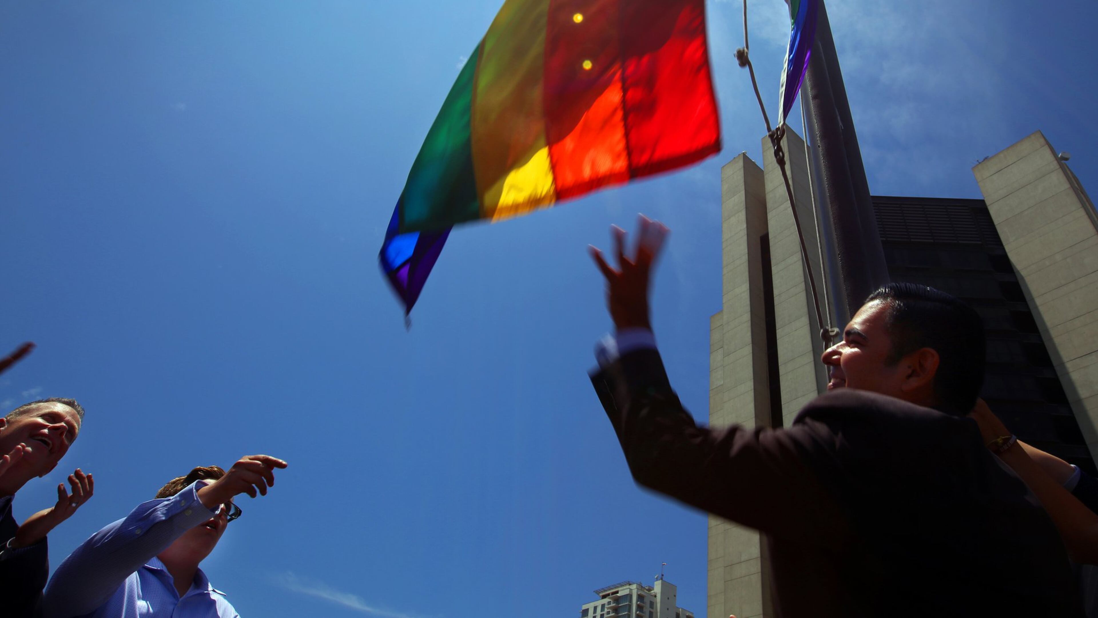 Long Beach, Calif., mayor Robert Garcia, right, the city’s first openly gay mayor, raises a Rainbow Pride Flag over the Civic Plaza in response to a U.S. Supreme Court ruling legalizing same-sex marriage on Friday, June 26, 2015. (Rick Loomis/Los Angeles Times/TNS)