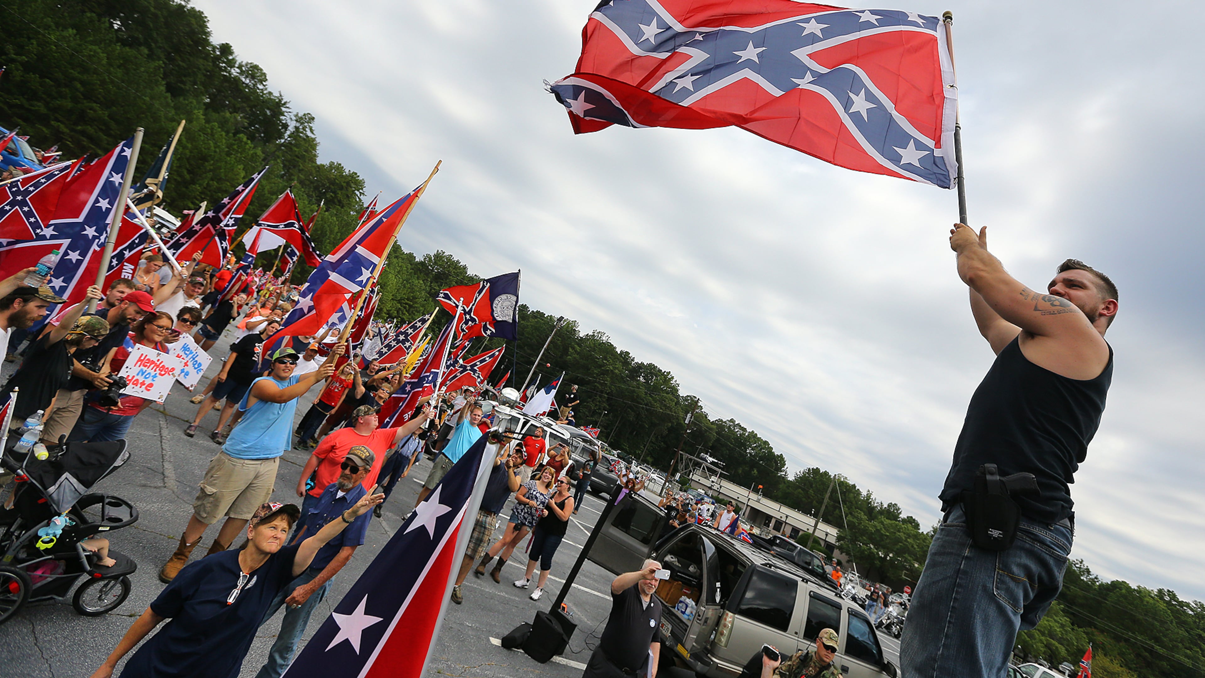 080215 STONE MOUNTAIN: Travis Conklin, Barnesville, waves a flag from the top of his truck durig a pro-Confederate flag rally at Stone Mountain Park on Saturday, August 1, 2015, in Stone Mountain. Curtis Compton / ccompton@ajc.com