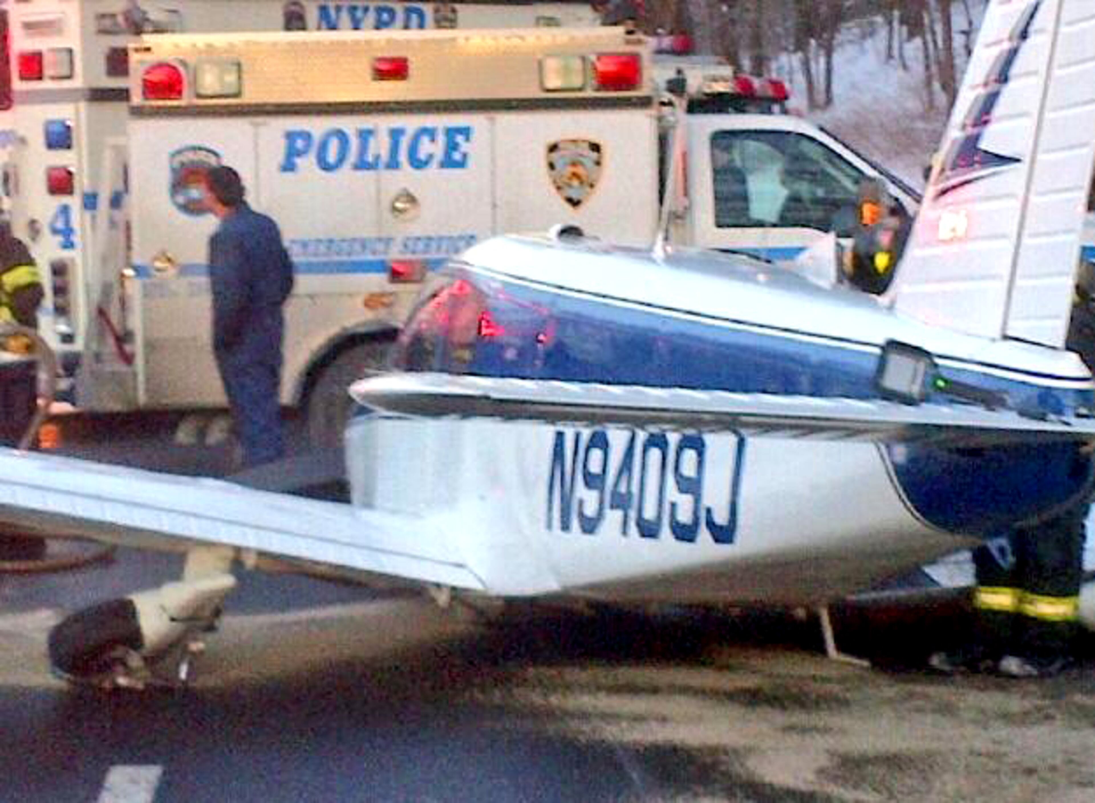 In this photo downloaded from the New York City Police Department's Twitter account, a light airplane's fuselage rests on the roadway after its pilot made an emergency landing on the Major Deegan Expressway in the Bronx borough of New York, Saturday, Jan. 5, 2014. Officials said that there were no serious injuries after the Piper PA-28, set down at around 3:20 p.m. on the northbound side of the highway. After safely removing the fuel from the aircraft, a flatbed truck eventually carried the plane off the highway.