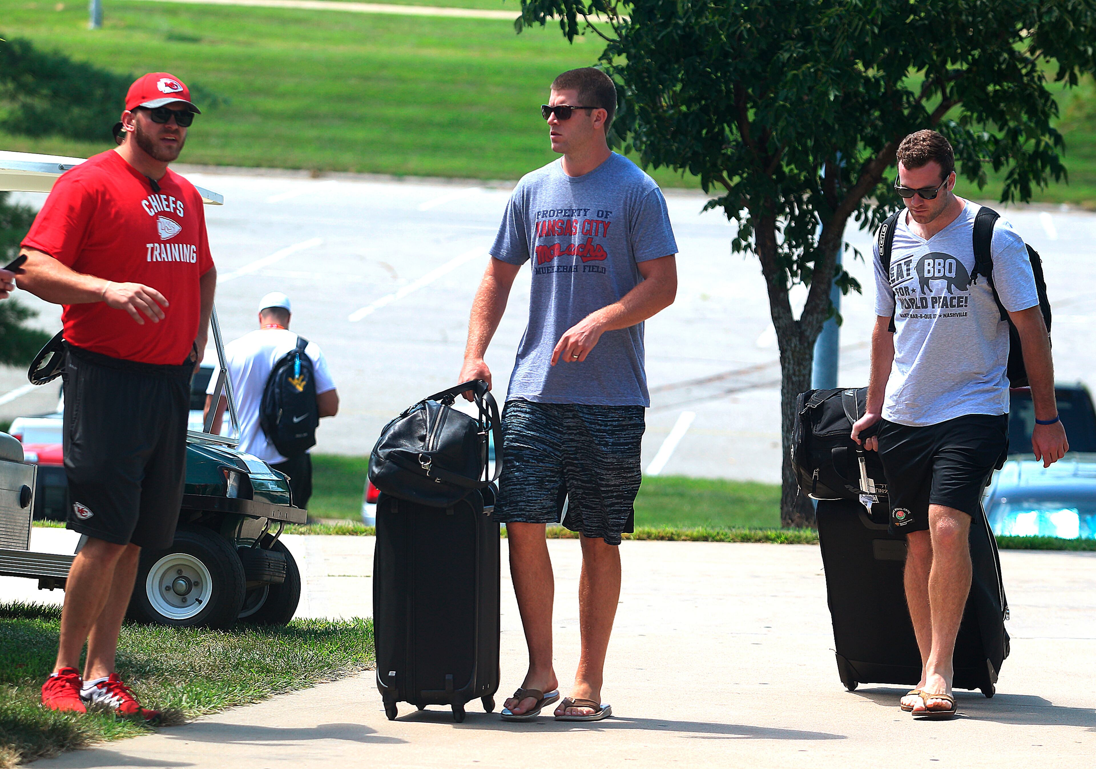 Kansas City Chiefs quarterbacks Tyler Bray, center, and Kevin Hogan, right, walk to a building as players arrive for NFL football training camp at Missouri Western State on Tuesday, July 26, 2016, in St. Joseph, Mo. (Dougal Brownlie/St. Joseph News-Press via AP)
