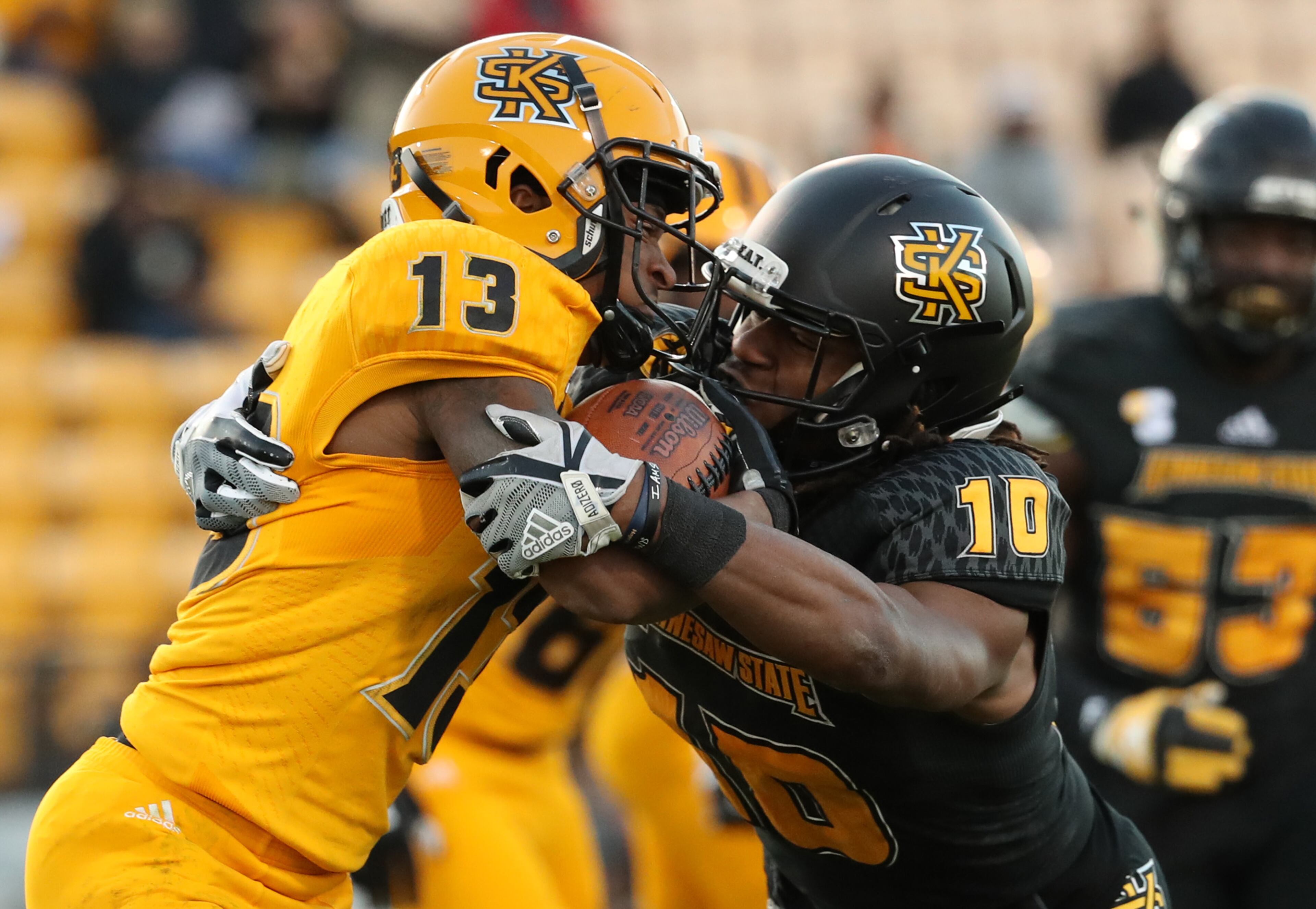 March 22, 2019 - Kennesaw, Ga: Kennesaw State Owls running back Jervon Kyles (13) is tackled by defensive back Quae Drake (10) during the KSU spring football game at Fifth Third Bank Stadium Friday, March 22, 2019 in Kennesaw, Ga.. (JASON GETZ/SPECIAL TO THE AJC)