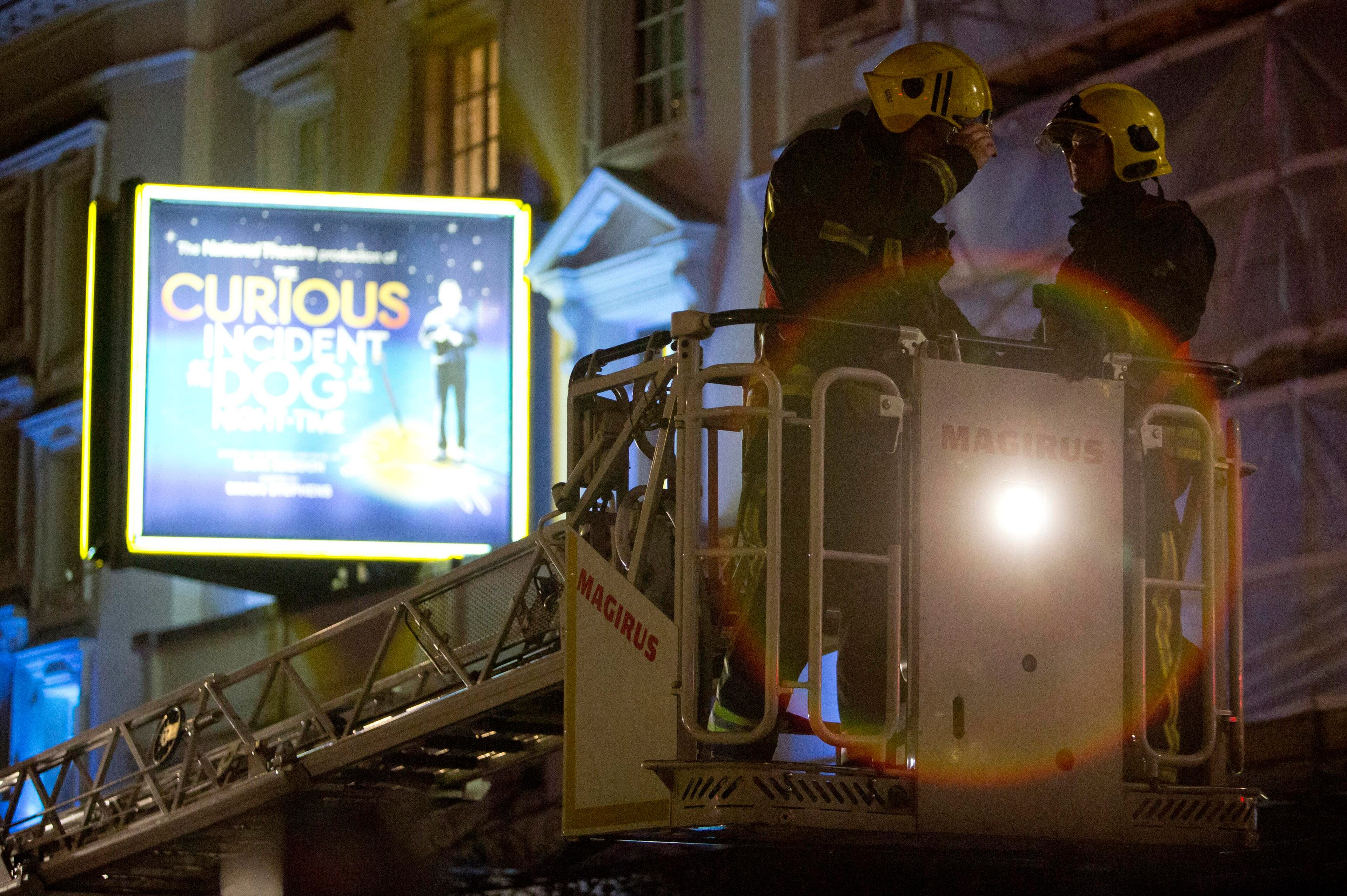 Emergency services use a cherry picker to look at the roof of the Apollo Theatre on Shaftesbury Avenue after part of the ceiling collapsed in central London December 19, 2013. Emergency services said nearly 90 people had been injured in a packed London theatre on Thursday when part of the ceiling collapsed during a performance, bringing the city's West End theatre district to a standstill.The audience was showered with masonry and debris following the incident at the Apollo Theatre, where about 720 people including many families were watching the hugely popular play "The Curious Incident of the Dog in the Night-Time."