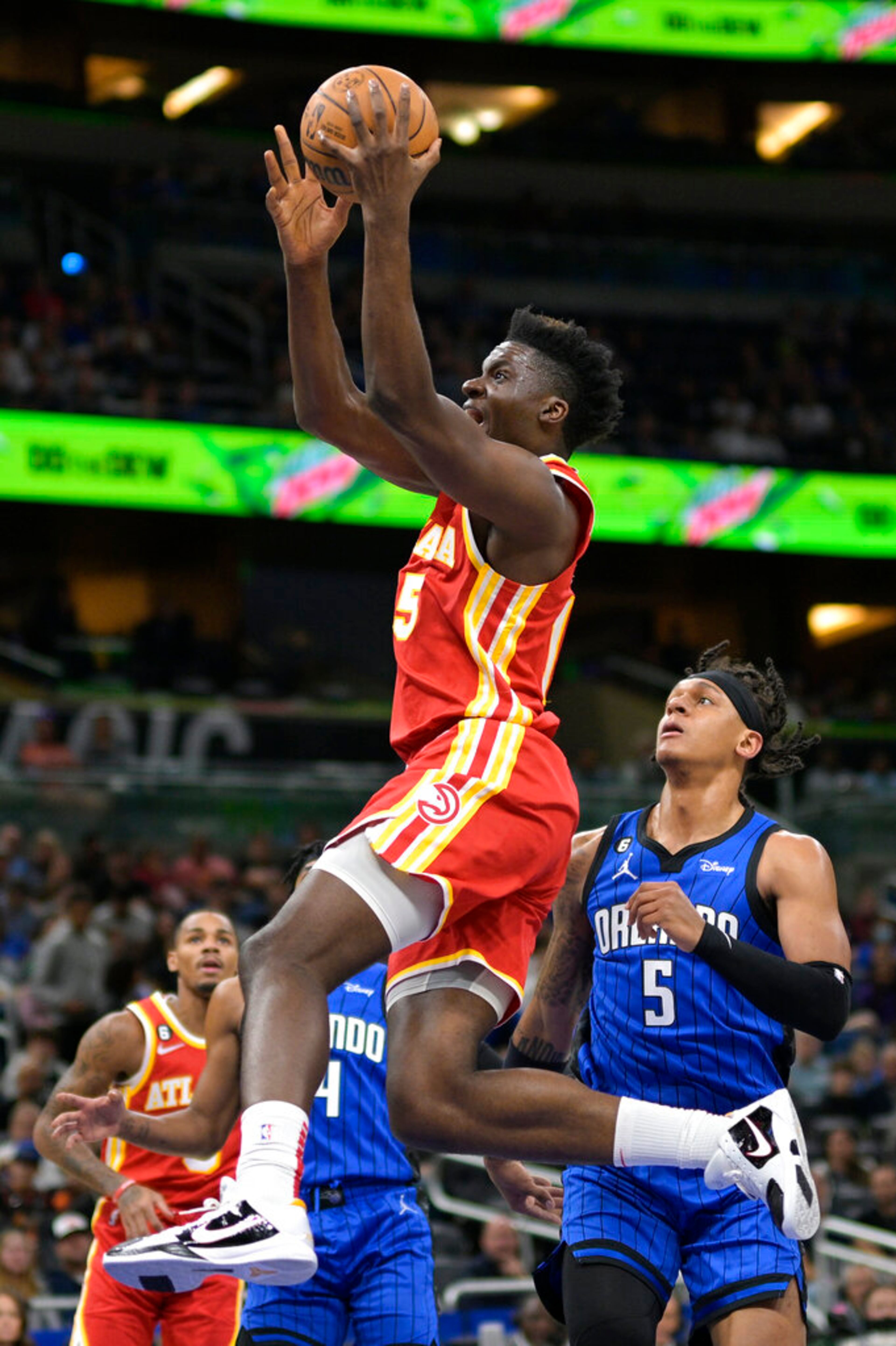 Atlanta Hawks center Clint Capela goes up for a shot in front of Orlando Magic forward Paolo Banchero (5) during the first half of an NBA basketball game Wednesday, Nov. 30, 2022, in Orlando, Fla. (AP Photo/Phelan M. Ebenhack)