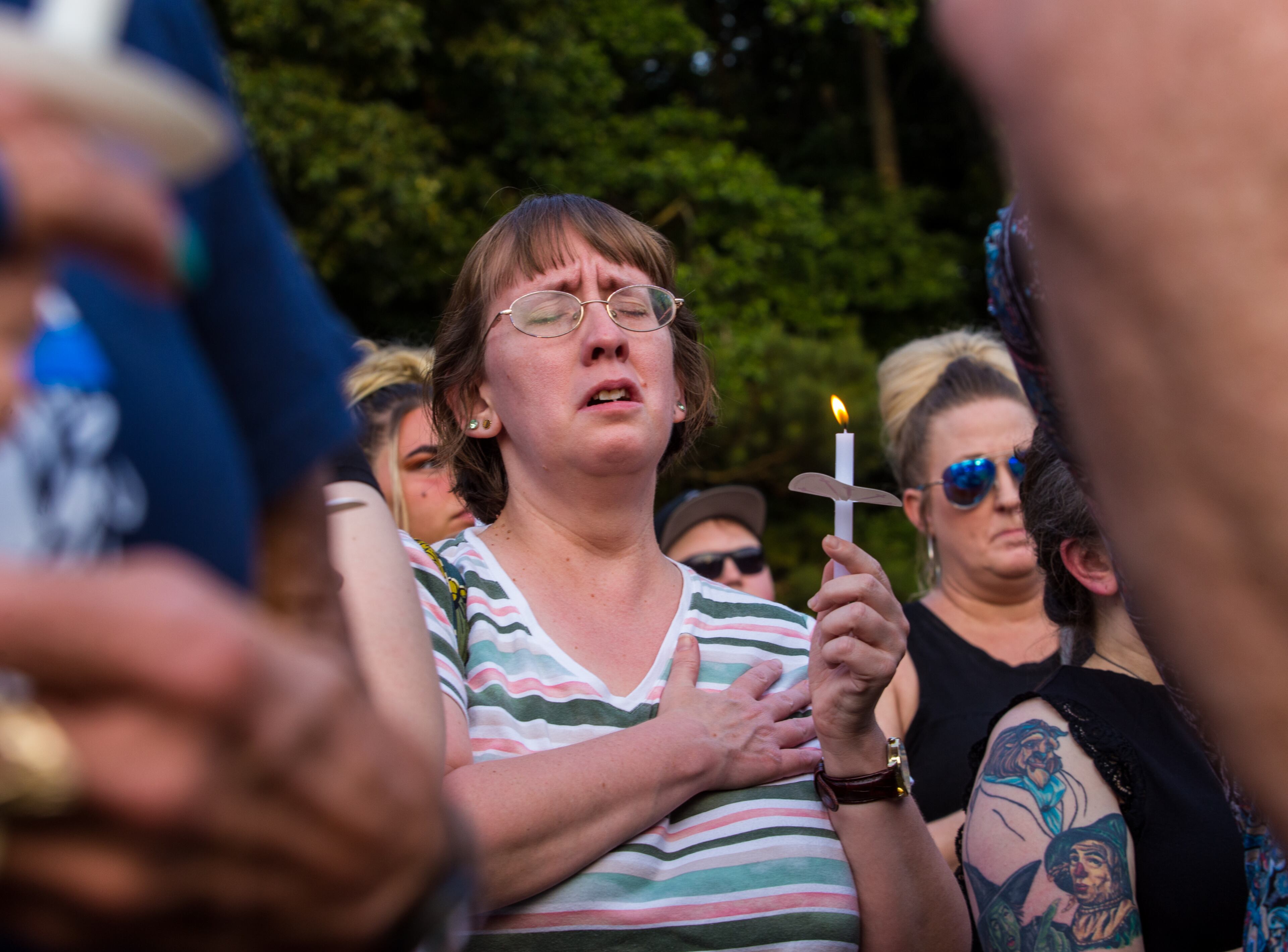Members of the Holly Springs community and neighboring police departments gather at Barrett Park for a candlelight vigil for Police Officer Joe Burson on Friday, June 18, 2021 after he was killed during a traffic stop earlier this week. (Jenni Girtman for The Atlanta Journal-Constitution)