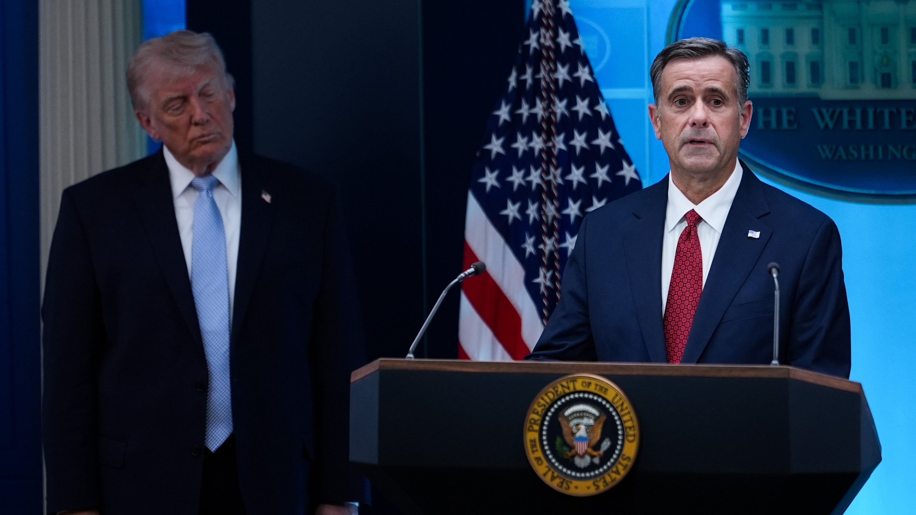 FILE - CIA Director John Ratcliffe, accompanied by President Donald Trump, speaks with reporters in the James Brady Press Briefing Room at the White House in Washington, April 6, 2026, File)