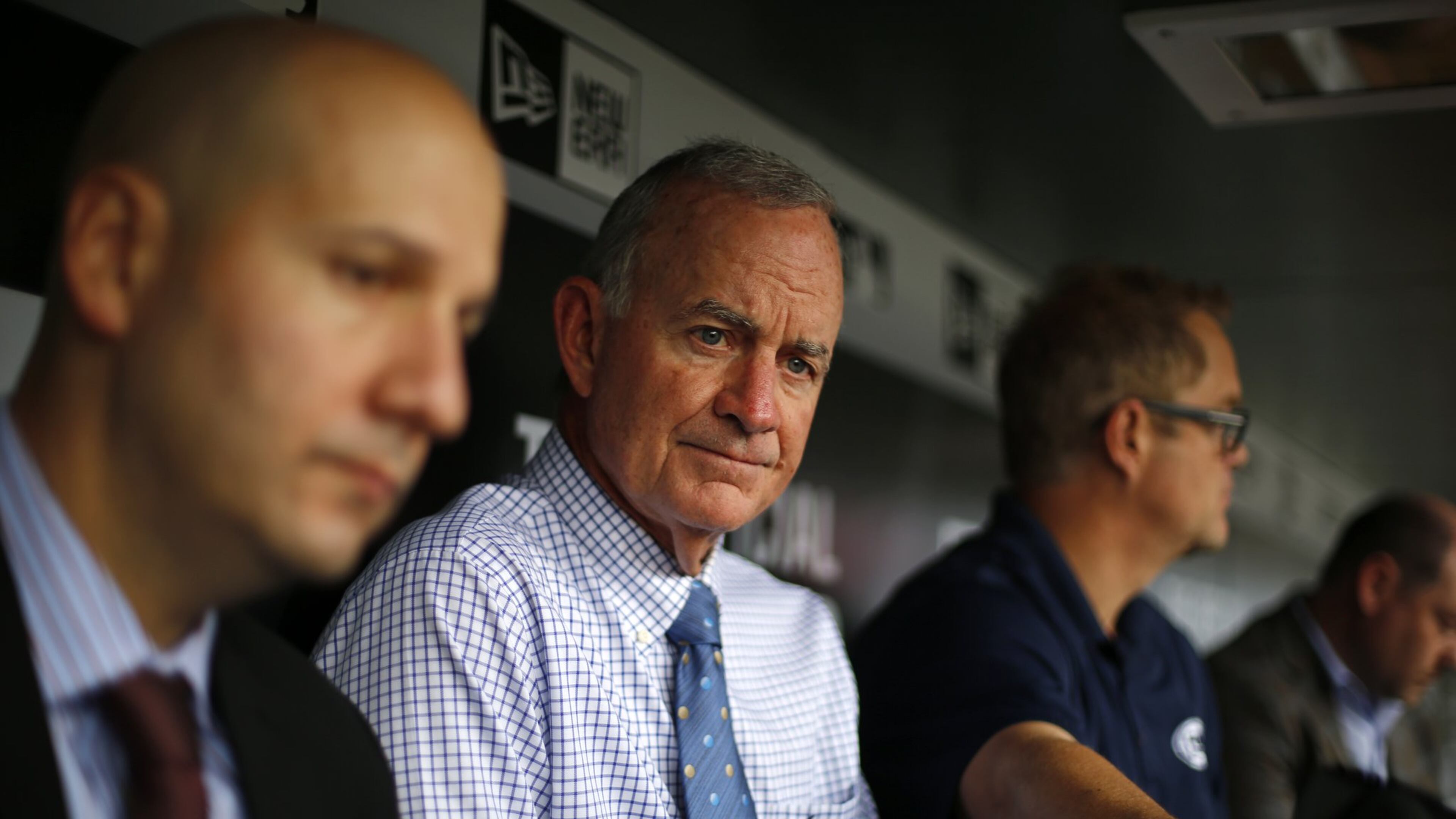 Atlanta Braves president of baseball operations John Hart, center, and general manager John Coppolella, left, meet with reporters in the dugout before game against the Pittsburgh Pirates in Pittsburgh, Tuesday, May 17, 2016. (AP Photo/Gene J. Puskar)