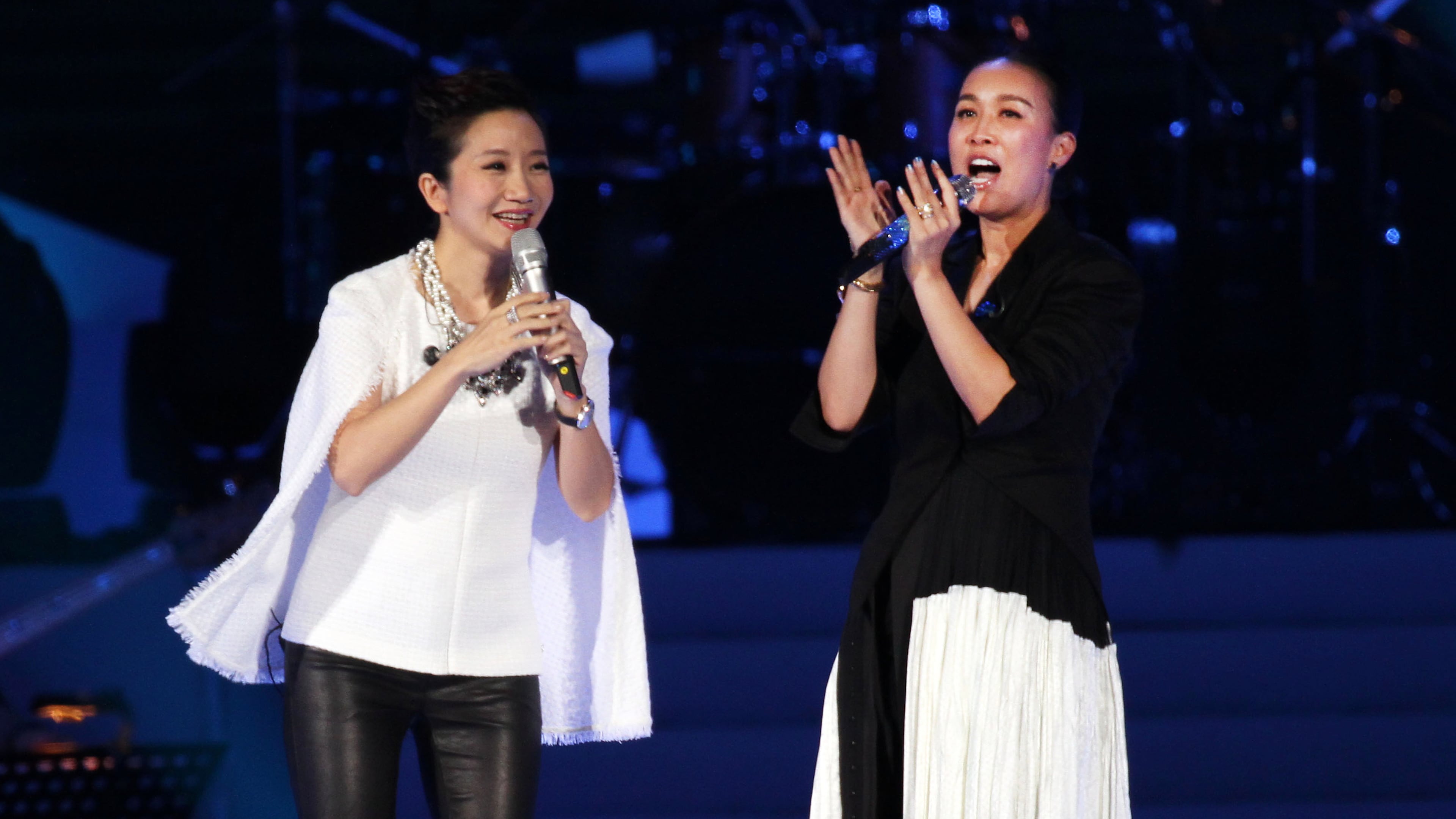FILE - Chinese singer Na Ying, right, and Taiwanese singer Matilda Tao performs during an public welfare Concert for abused girls at the Taipei Arena in Taipei, Taiwan, April 20, 2014. (AP Photo/Chiang Ying-ying, File)