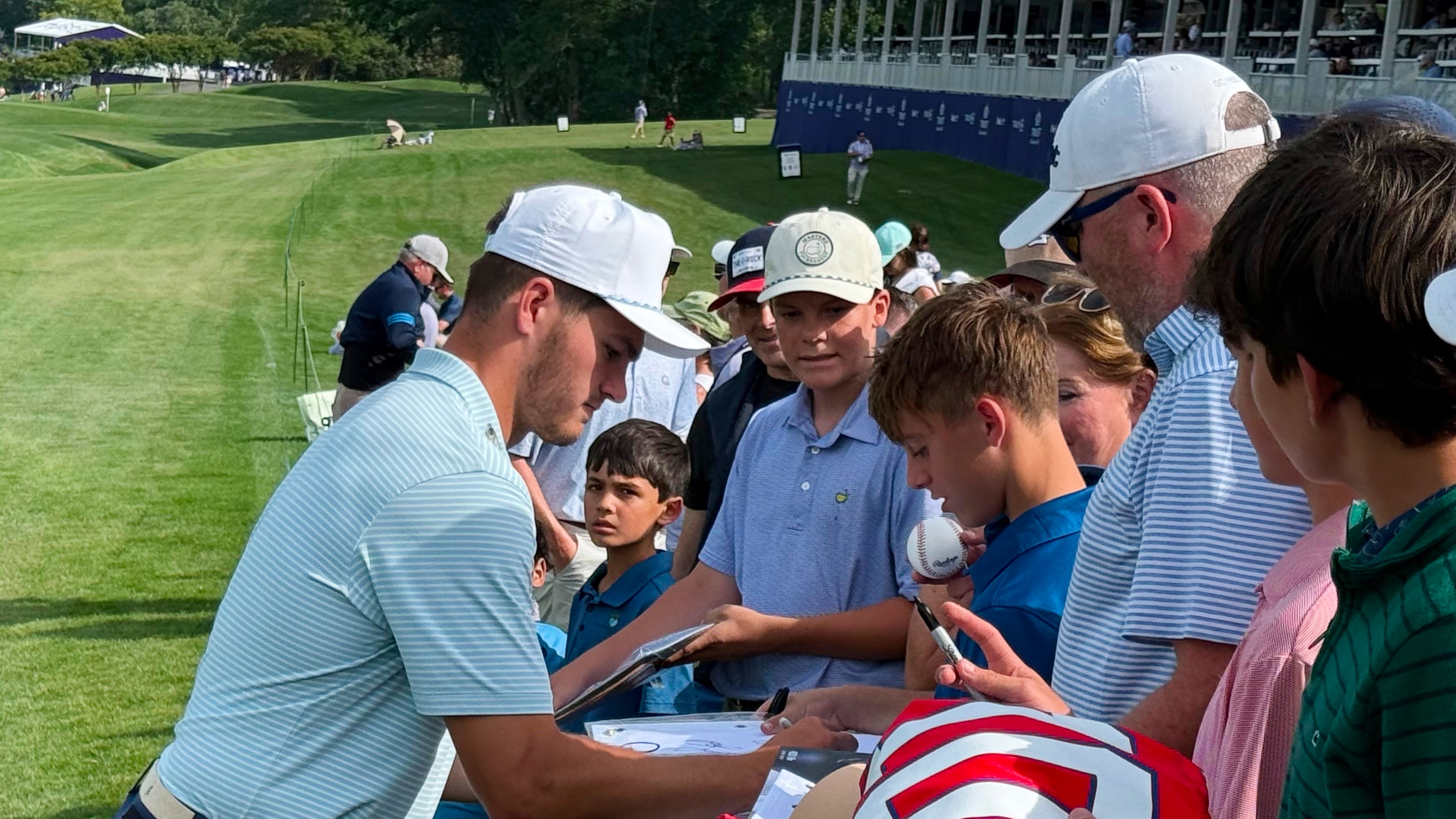 New England Patriots quarterback Drake Maye signs autographs for fans after the pro-am at the Trust Championship golf tournament, Wednesday, May 6, 2026, at Quail Hollow Club in Charlotte. (AP Photo/Steve Reed)