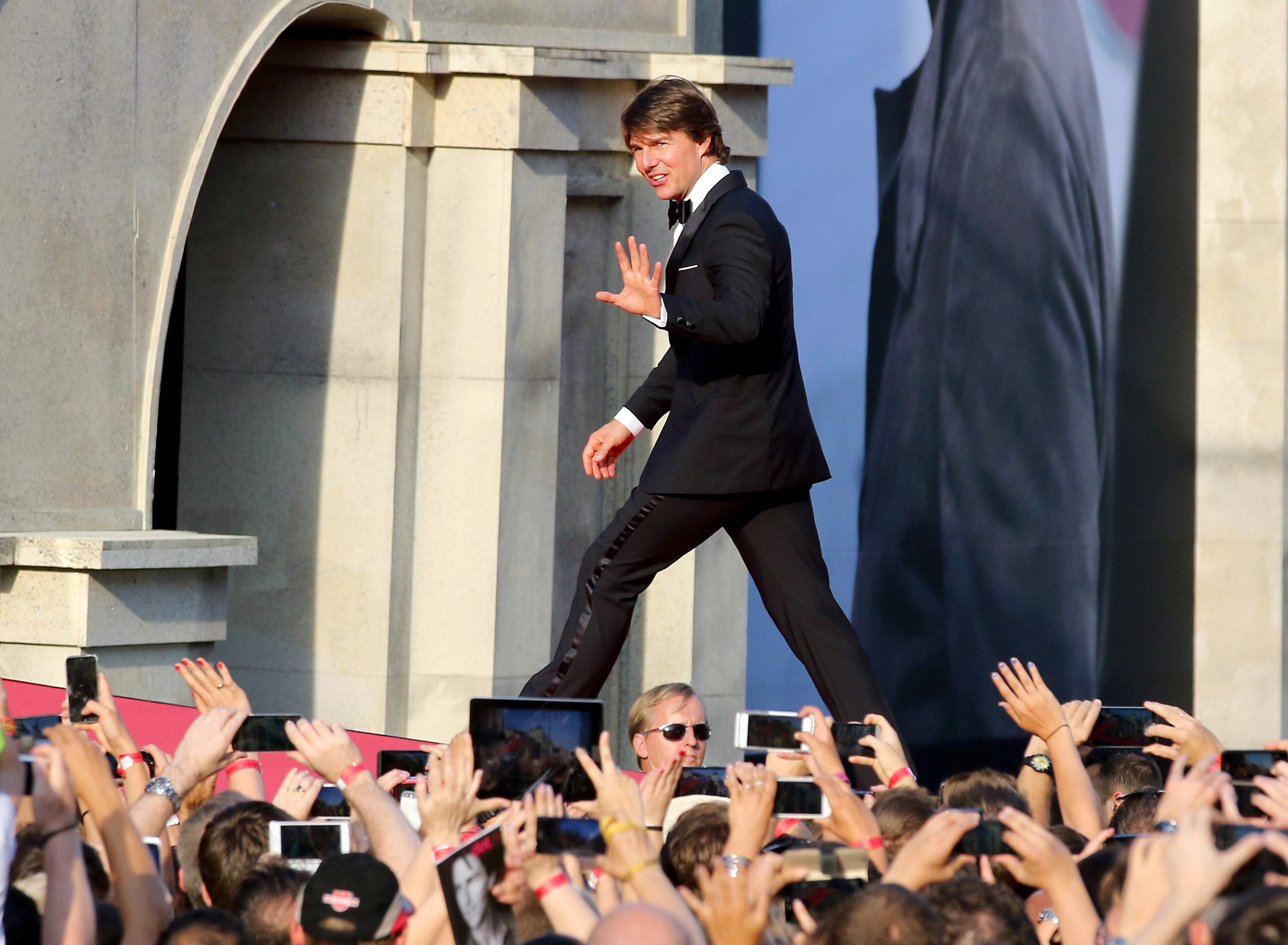 US actor Tom Cruise waves to fans as he attends the "Mission: Impossible -- Rogue Nation" World Premiere, at the Vienna State Opera in Vienna, Austria, Thursday, July 23, 2015. (AP Photo/Ronald Zak)