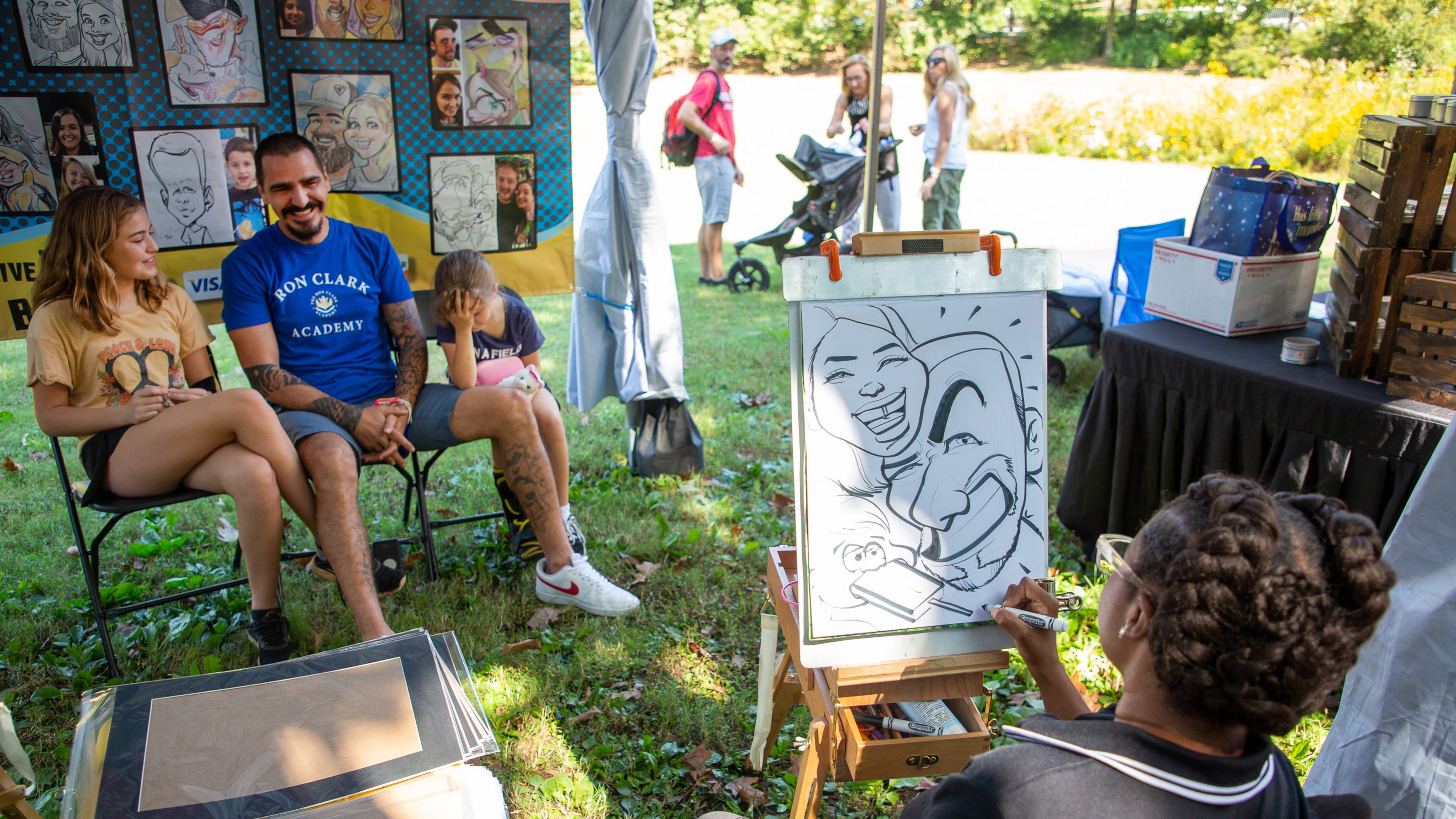Artist Lillian Cotton draws a caricature of a family during the Festival on Ponce on Sunday, October 10, 2021, in Olmsted Linear Park. (Photo: Steve Schaefer for The Atlanta Journal-Constitution)
