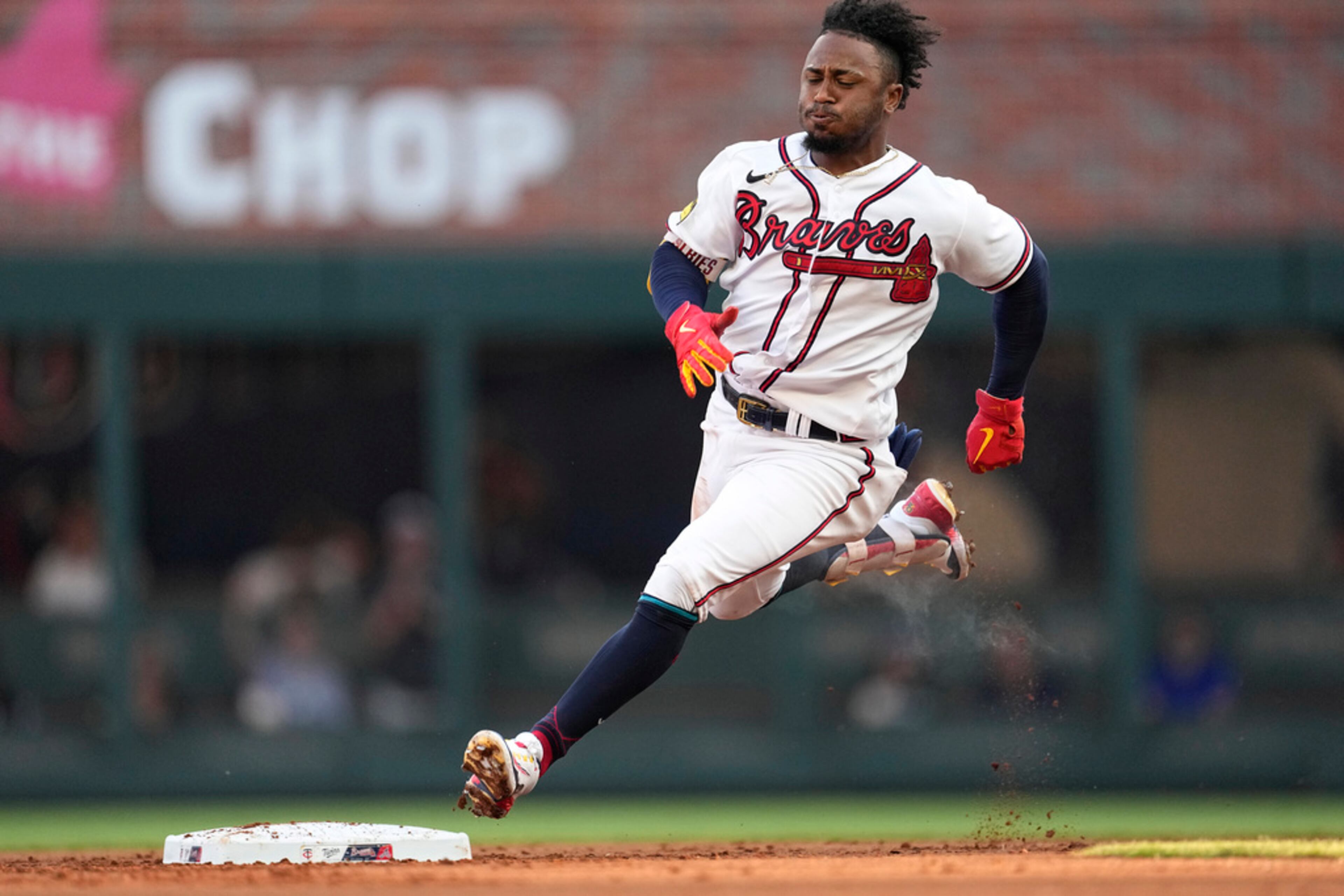 Atlanta Braves' Ozzie Albies rounds second base after hitting a triple against the Minnesota Twins during the first inning of a baseball game Tuesday, June 27, 2023, in Atlanta. (AP Photo/John Bazemore)