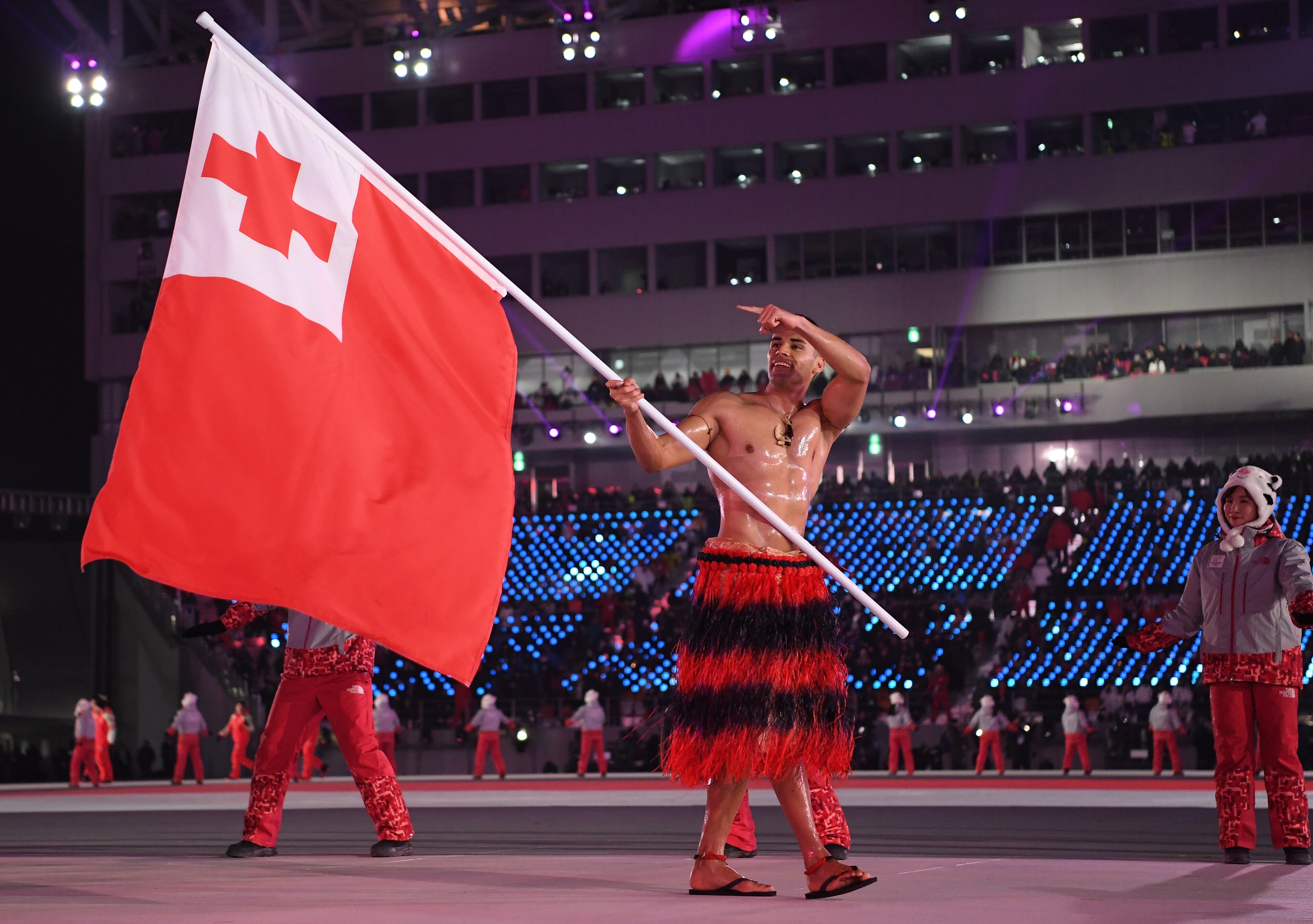 PYEONGCHANG-GUN, SOUTH KOREA - FEBRUARY 09: Flag bearer Pita Taufatofua of Tonga leads his country out during the Opening Ceremony of the PyeongChang 2018 Winter Olympic Games at PyeongChang Olympic Stadium on February 9, 2018 in Pyeongchang-gun, South Korea. (Photo by Quinn Rooney/Getty Images)