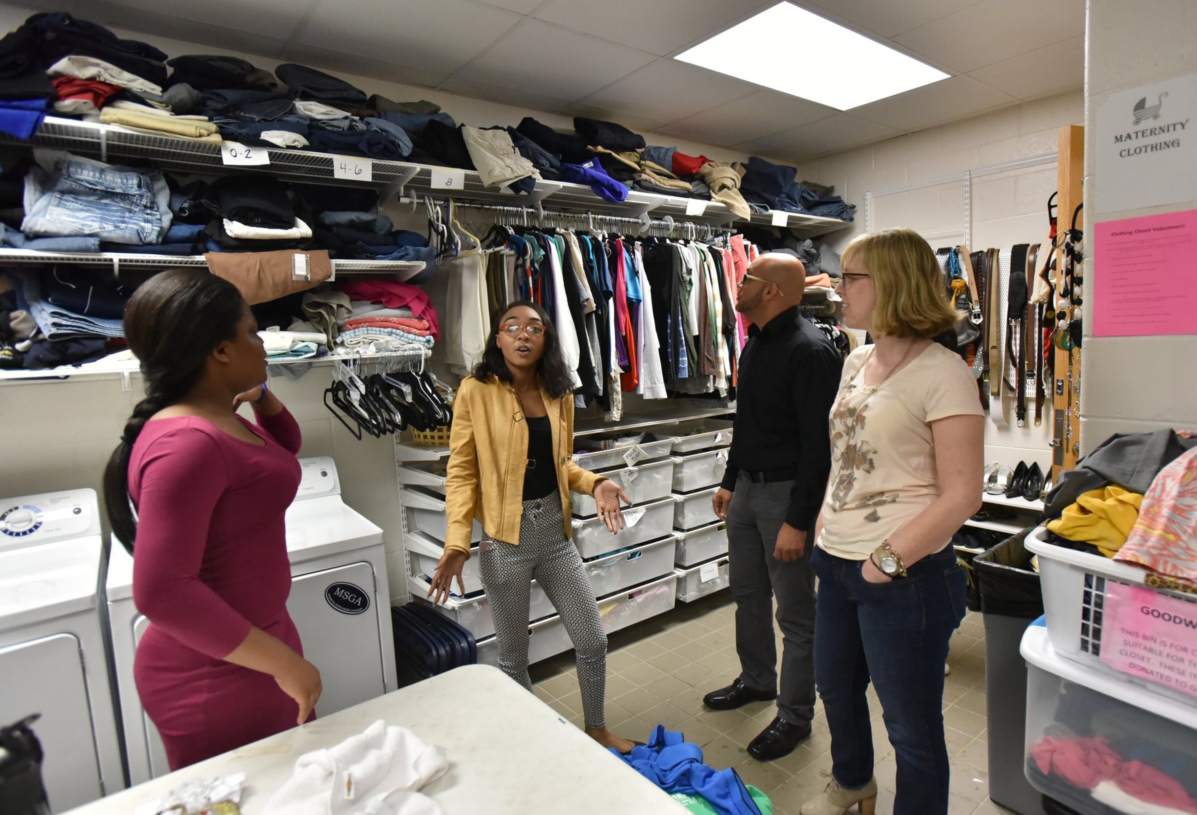 April 20, 2017 Marietta - R’moni Clark-Hudson (second from left), 17, shows the Graduate Marietta Student Success Center’s Clothing Closet and Laundry area to visitors in Marietta High School on Thursday, April 20, 2017. Leigh Colburn has earned plaudits for her work with at-risk students at the 2-year-old Graduate Marietta Student Success Center, an experiment housed inside the city’s high school. Educators from across Georgia have made pilgrimages to the center, hoping to find ideas they can copy. HYOSUB SHIN / HSHIN@AJC.COM