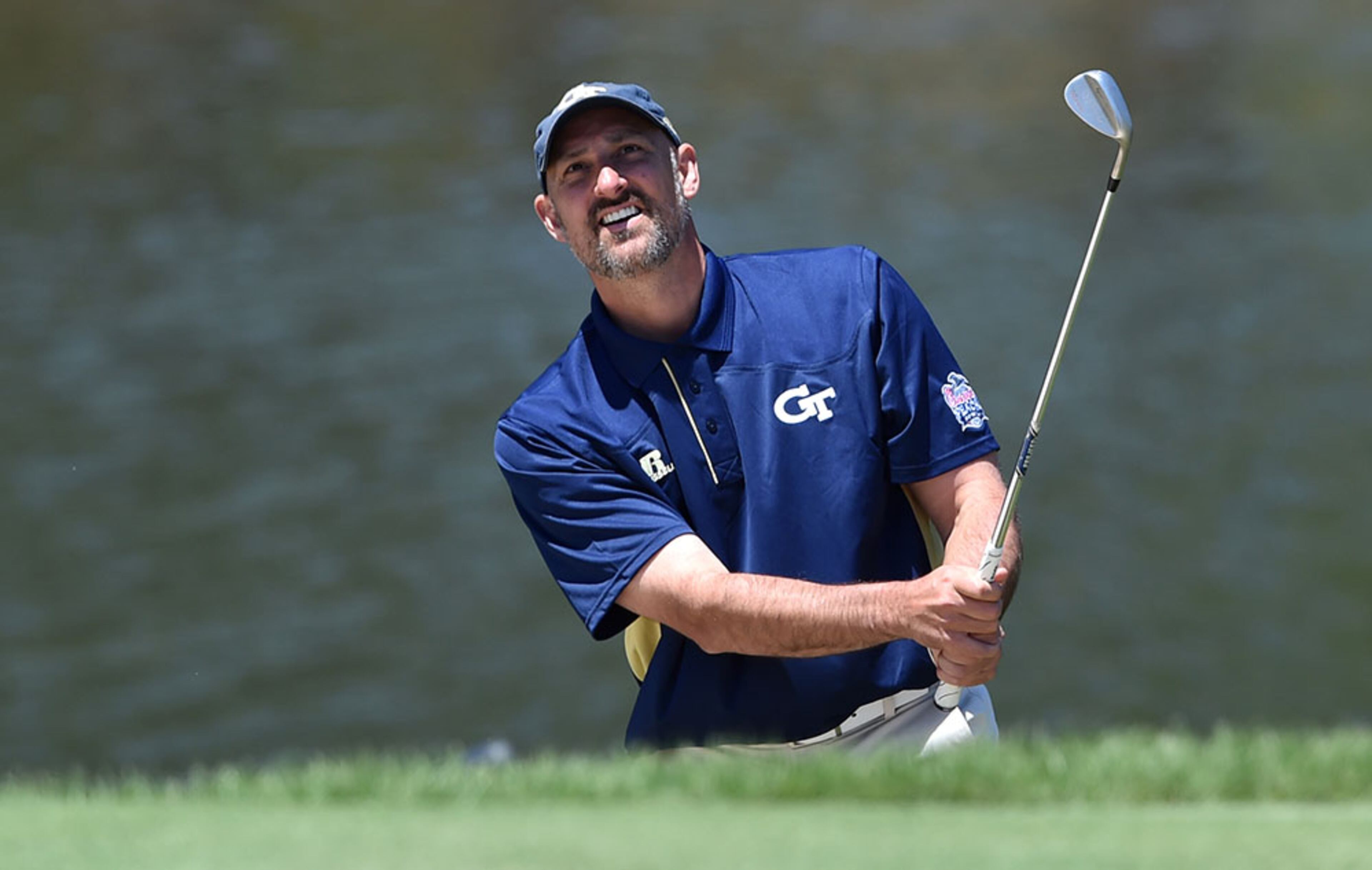 Former Georgia tech basketball standout Jon Barry chips onto the green during the Chick-fil-A Peach Bowl Challenge on Tuesday, April 28, 2015, at Reynolds Plantation at Lake Oconee.