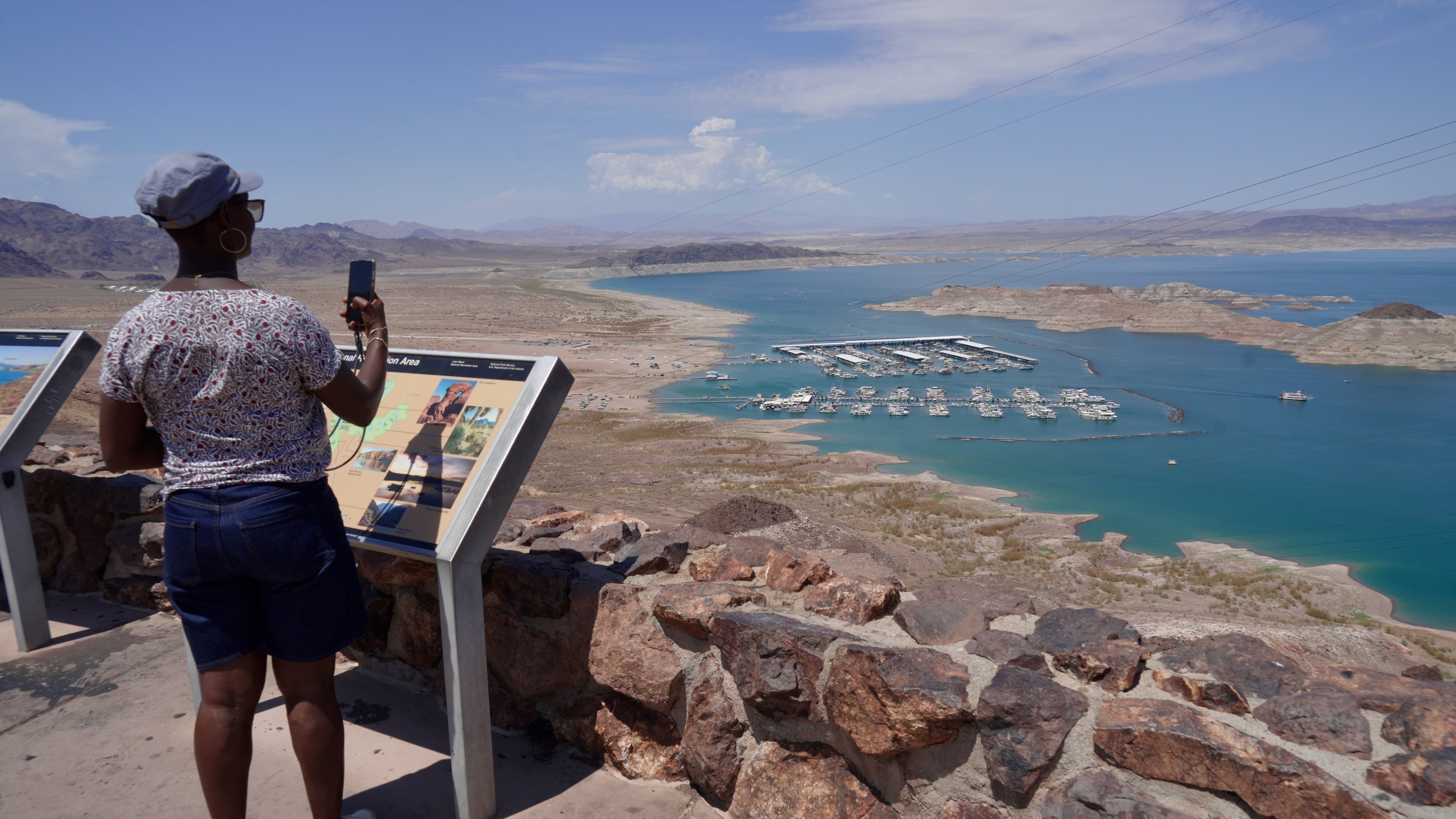 A tourist takes a photo of Lake Mead near Boulder City, Nev., on Friday, Aug. 7, 2026. (AP Photo/Ty ONeil)