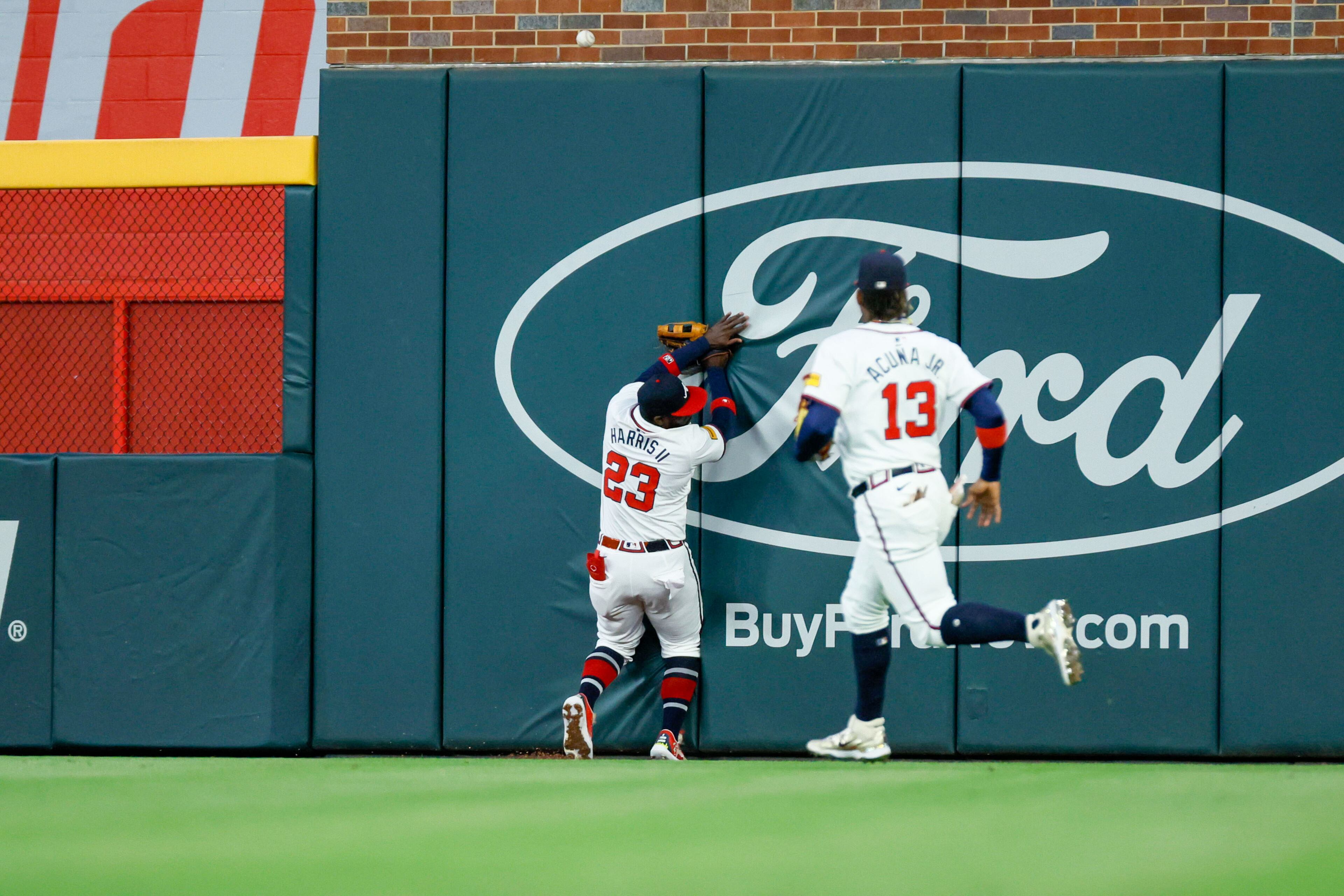 Atlanta Braves outfielder Michael Harris II crashes into the wall after losing sight of the ball on a double by Texas Rangers outfielder Adolis García during the fifth inning against the Texas Rangers at Truist Park on Sunday, April 21, 2024, in Atlanta.
(Miguel Martinez/ AJC)