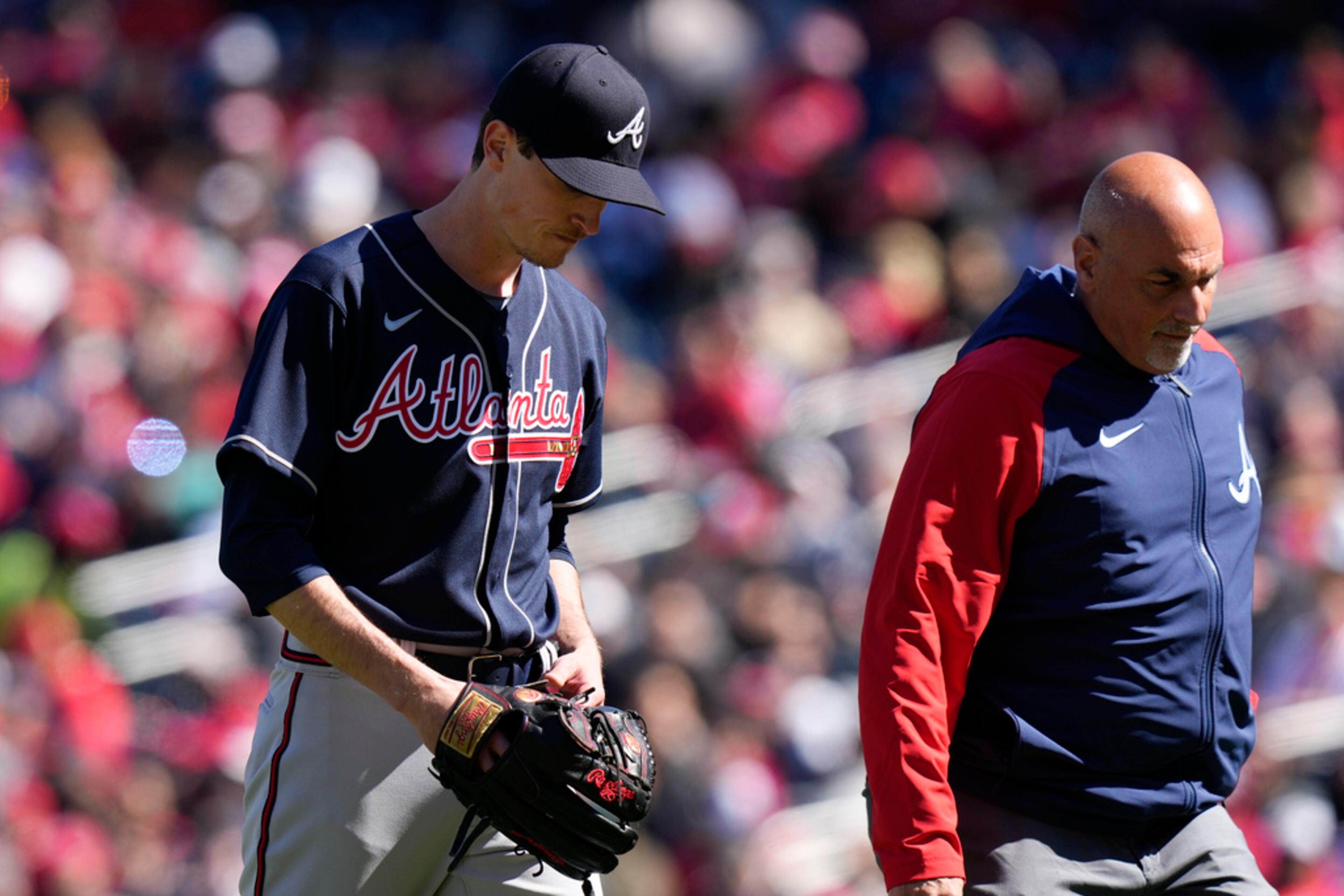 Atlanta Braves starting pitcher Max Fried, left, walks off the field due to a hamstring injury during the fourth inning of an opening day baseball game against the Washington Nationals at Nationals Park, Thursday, March 30, 2023, in Washington. (AP Photo/Alex Brandon)