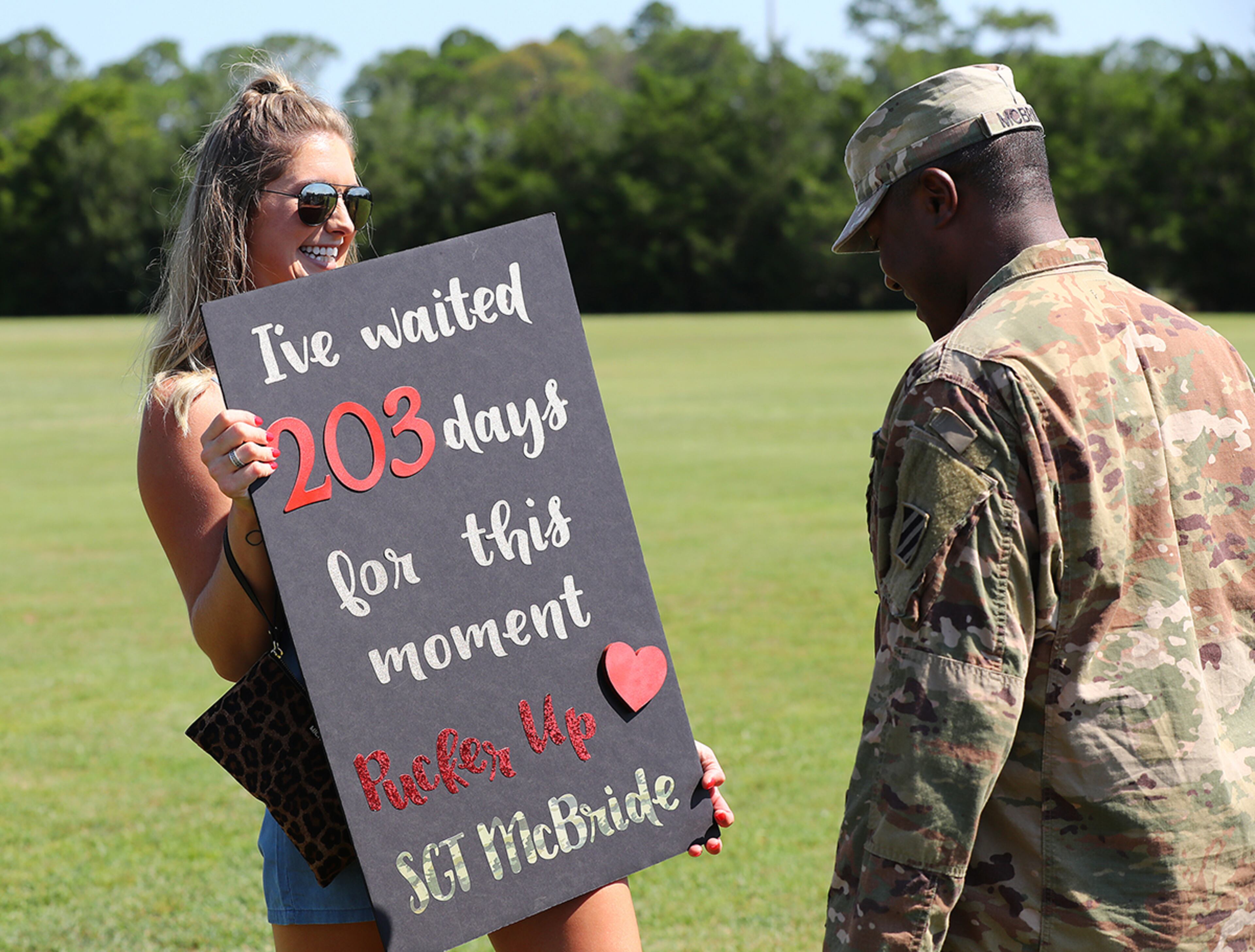 July 30, 2019 Fort Stewart: Sergeant Matthew McBride looks on as his girlfriend Taylor Butler greets him with her sign as soldiers of the 48th Infantry Brigade Combat Team representing units from across the state return home from deployment to Afghanistan in support of Operation Resolute Support at Cottrell Field on Tuesday, July 30, 2019, in Fort Stewart. Curtis Compton/ccompton@ajc.com