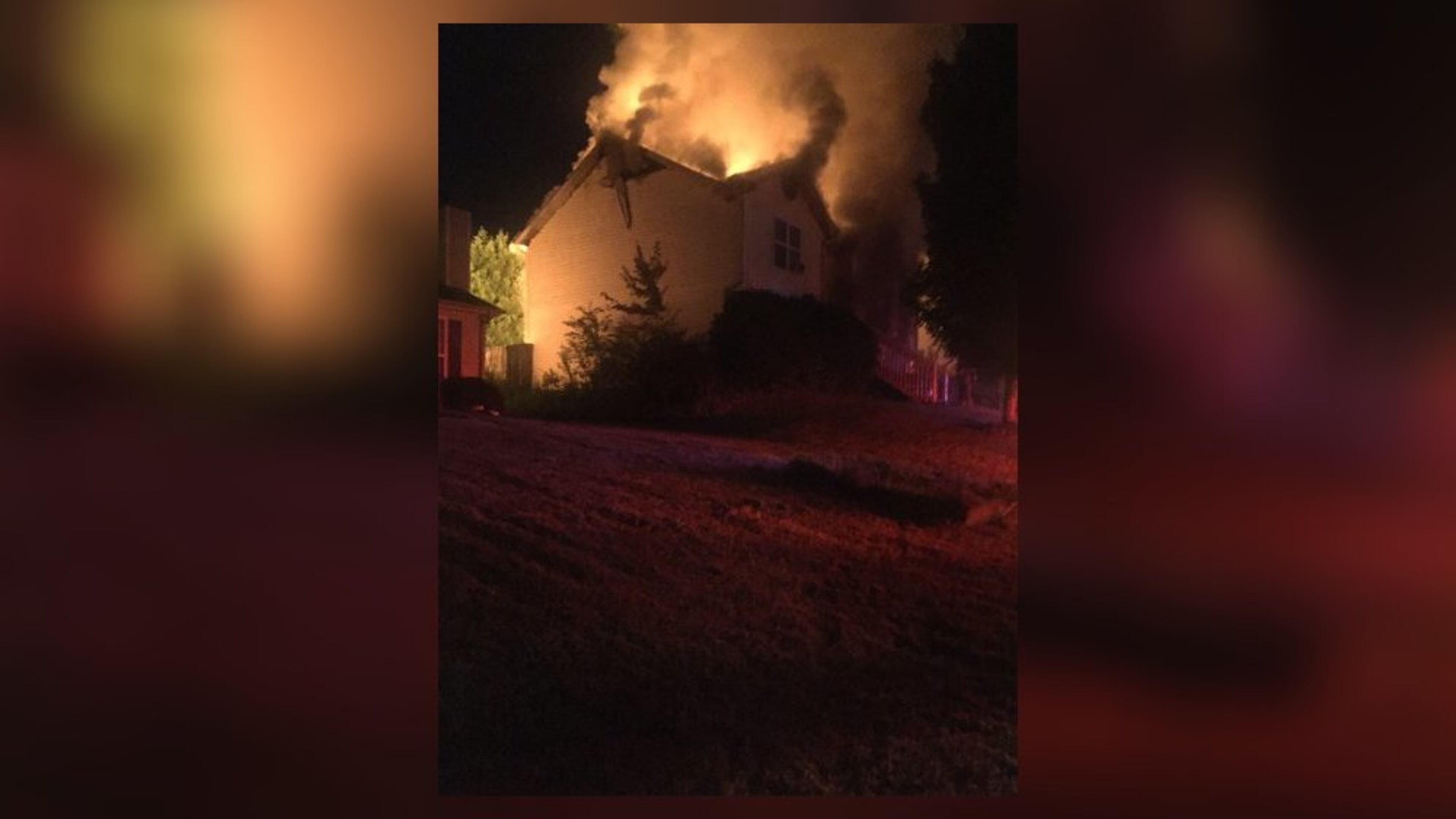 Officials said coals from a charcoal grill started a fire that damaged this house near Lawrenceville.