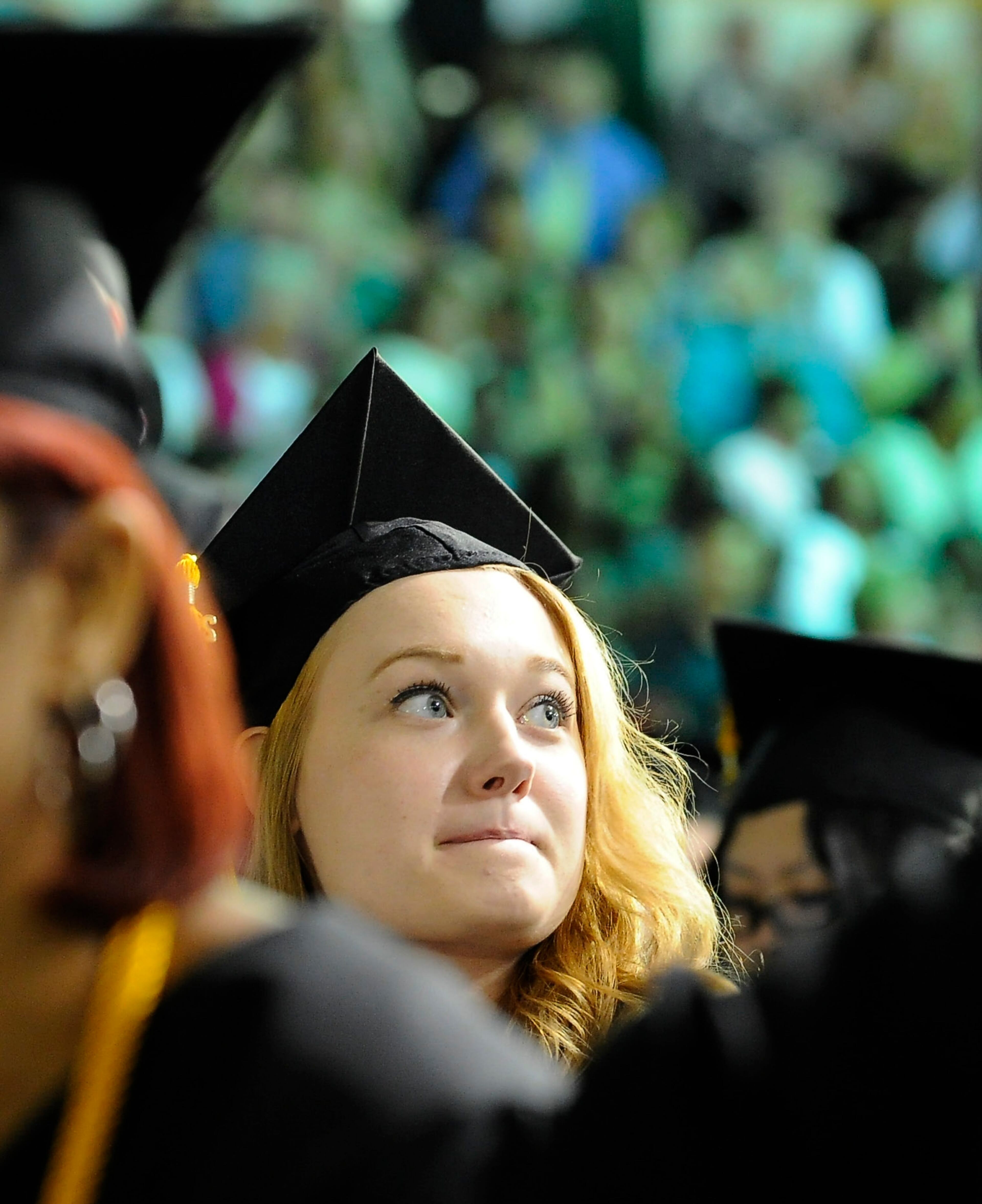 Southern Polytechnic State University summa cum laude psychology major Jennie Lambert looks at the crowd during the school's 109th spring commencement, which is also the last spring commencement before SPSU merges with Kennesaw State University next year, on Saturday, May 10, 2014, in Marietta, Ga. David Tulis / AJC Special