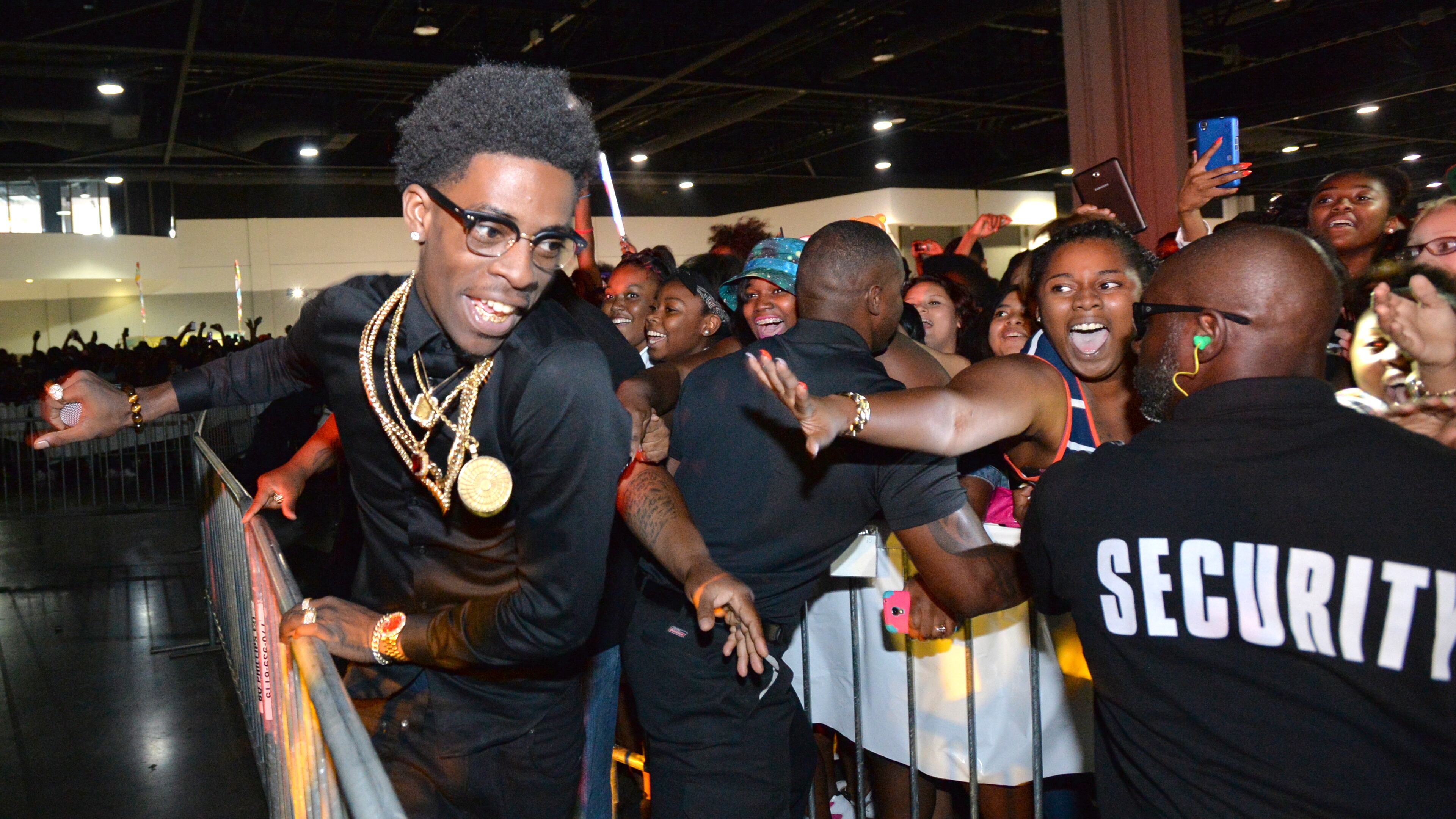 *LEAD PHOTO* July 12, 2014 Atlanta - Rich Homie Quan (left) tries to go back to the stage after he greeted fans during The 2014 V-103/WAOK Car & Bike Show at the Georgia World Congress Center on Saturday, July 12, 2014. V-103/WAOK presents the 11th Anniversary of the Car & Bike Show at the Georgia World Congress Center from Noon 9PM. In addition to the hottest tricked out rides, classics cars and custom bikes, the Car & Bike Show will feature performances by T.I and the Hustle Gang, T-Pain, Doug E. Fresh, Da Brat, Rich Homie Quan, Rico Love, August Alsina and more. HYOSUB SHIN / HSHIN@AJC.COM Rich Homie Quan will play a free show to promote voting in advance of the 2014 Georgia elections.