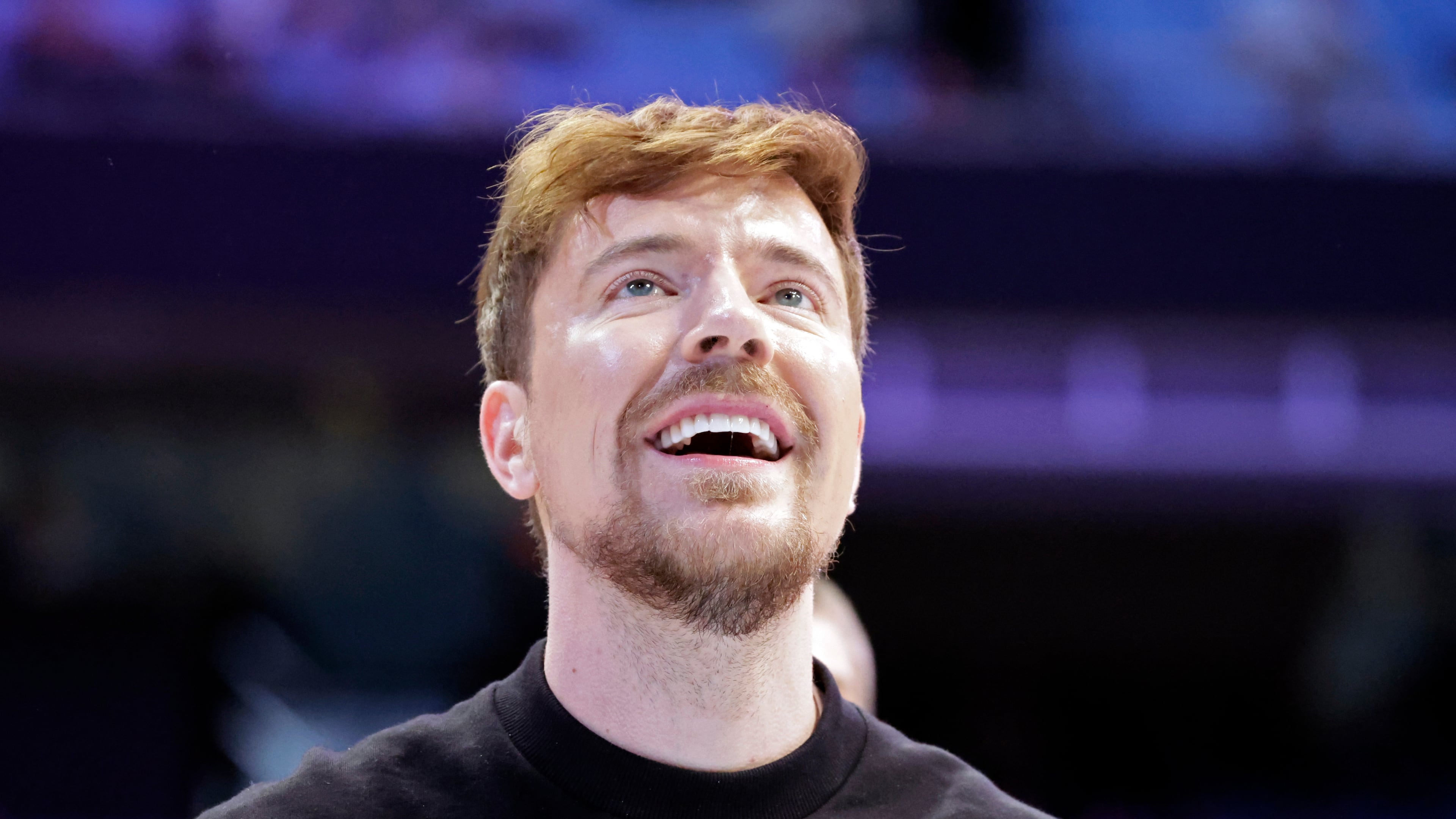 FILE - YouTube personality MrBeast, aka Jimmy Donaldson, watches a contestant's shot in a free throw shooting contest that he sponsored at the conclusion of of an NCAA college basketball game between USC Upstate and North Carolina, Dec. 13, 2025, in Chapel Hill, N.C. (AP Photo/Chris Seward, File)