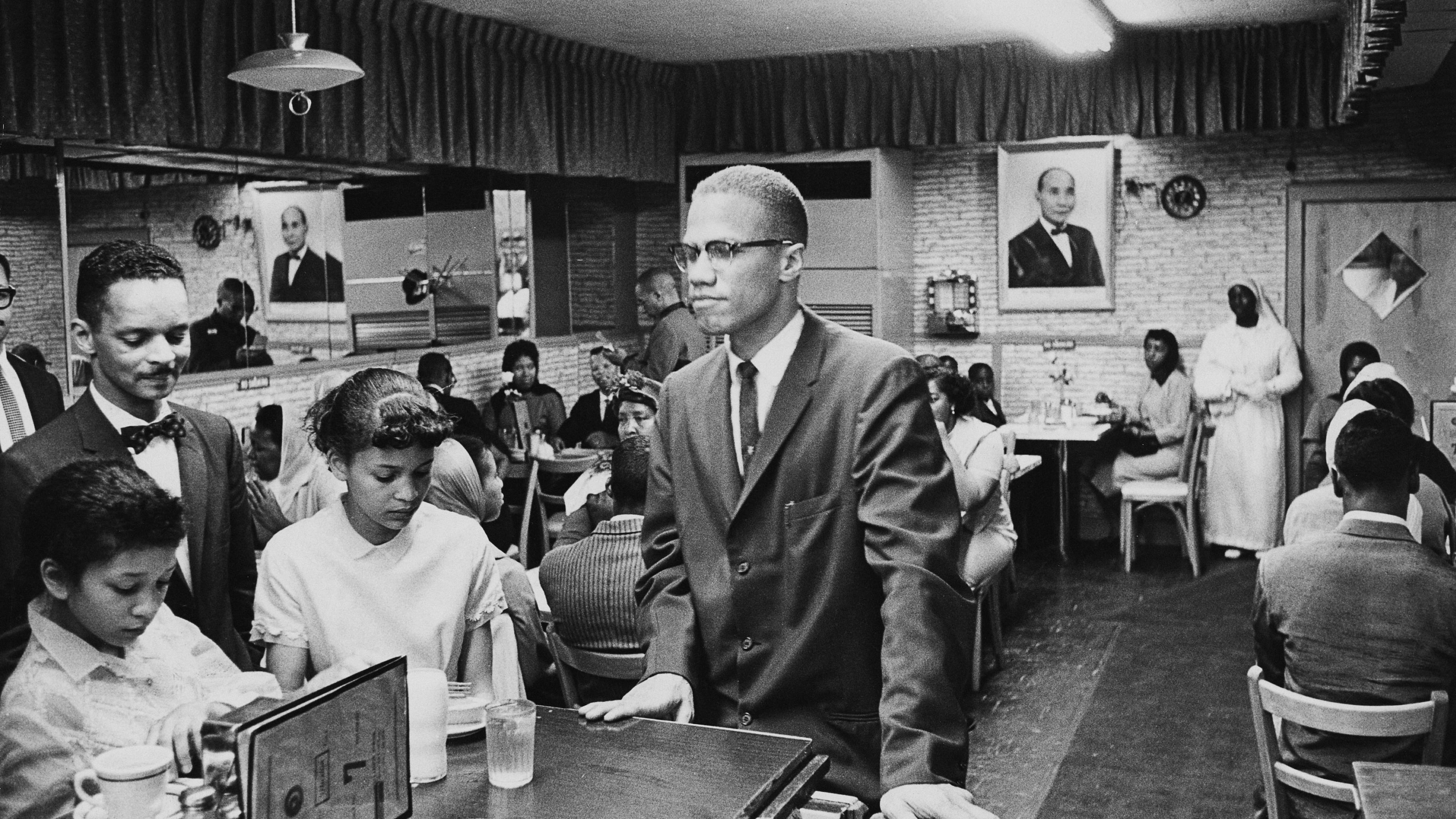 African-American Muslim minister and civil rights activist Malcolm X (1925 - 1965) at Temple 7, a Halal restaurant patronized by black Muslims, on Lenox Avenue and 116th Street, Harlem, New York, August 1963. (Photo by Richard Saunders/Pictorial Parade/Archive Photos/Getty Images)