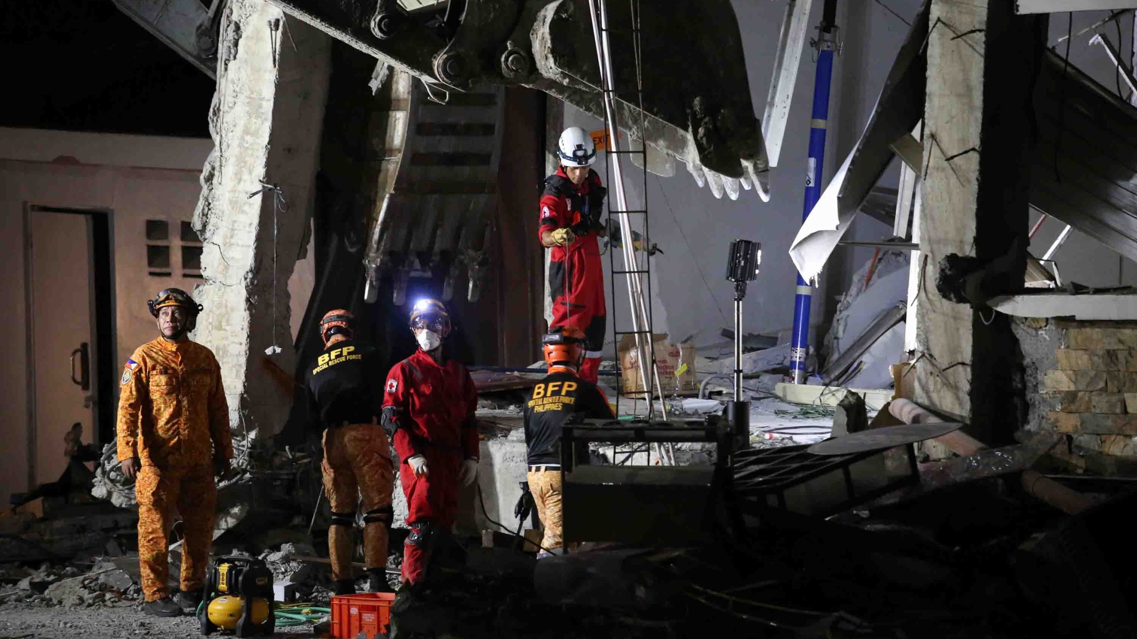 Rescuers use heavy equipment as they conduct a search and retrieval operation at a damaged building following an earthquake in General Santos, Philippines, Tuesday, June 9, 2026. (AP Photo/Basilio Sepe)