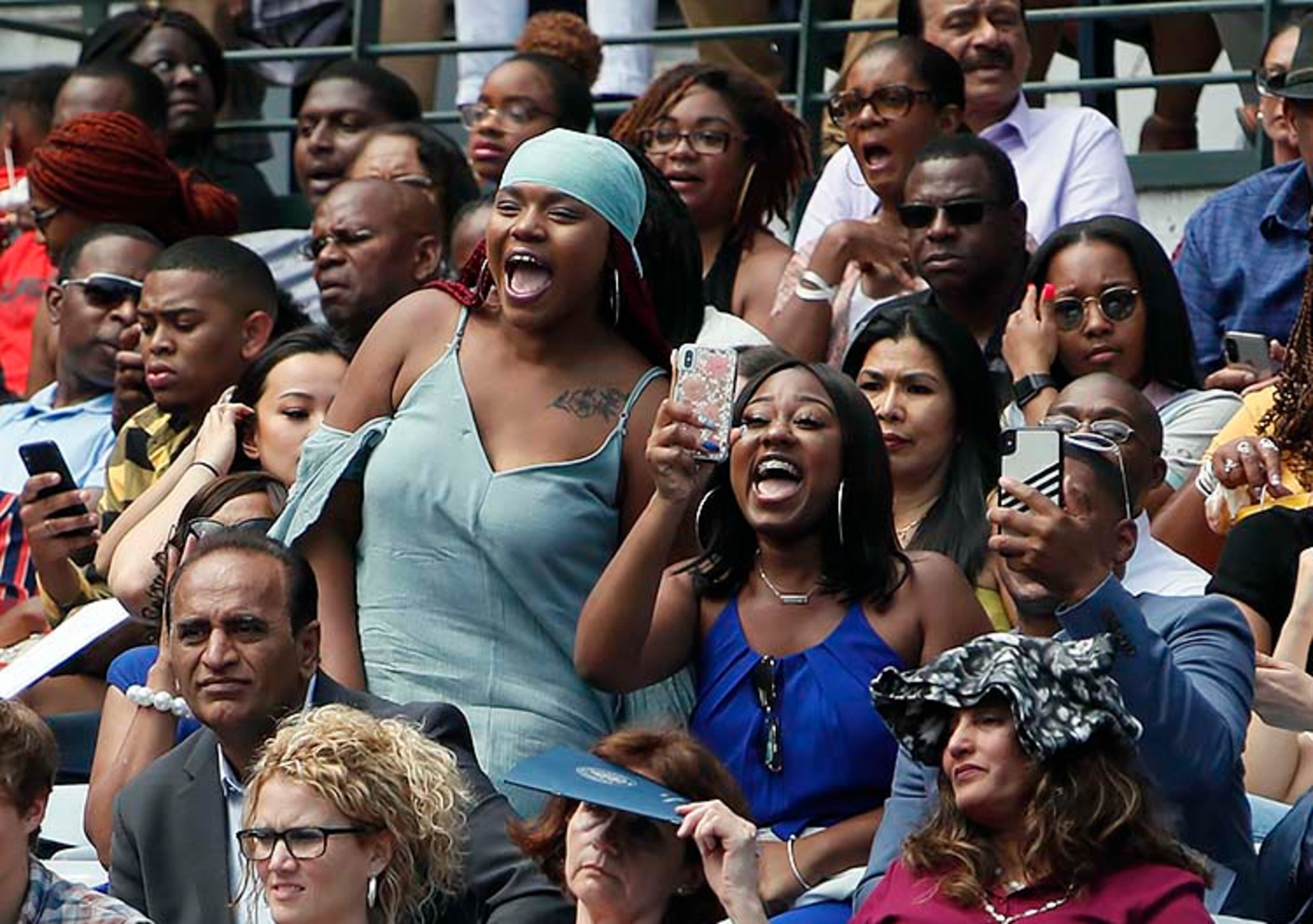 May 9, 2019 - Atlanta - Family members cheer for their graduate as their name is called to take the stage. Georgia State University is hosting its 104th Commencement Monday, May 6 through Tuesday, May 14 at Panther Stadium in Atlanta. Six schools held their graduation on Thursday. Bob Andres / bandres@ajc.com