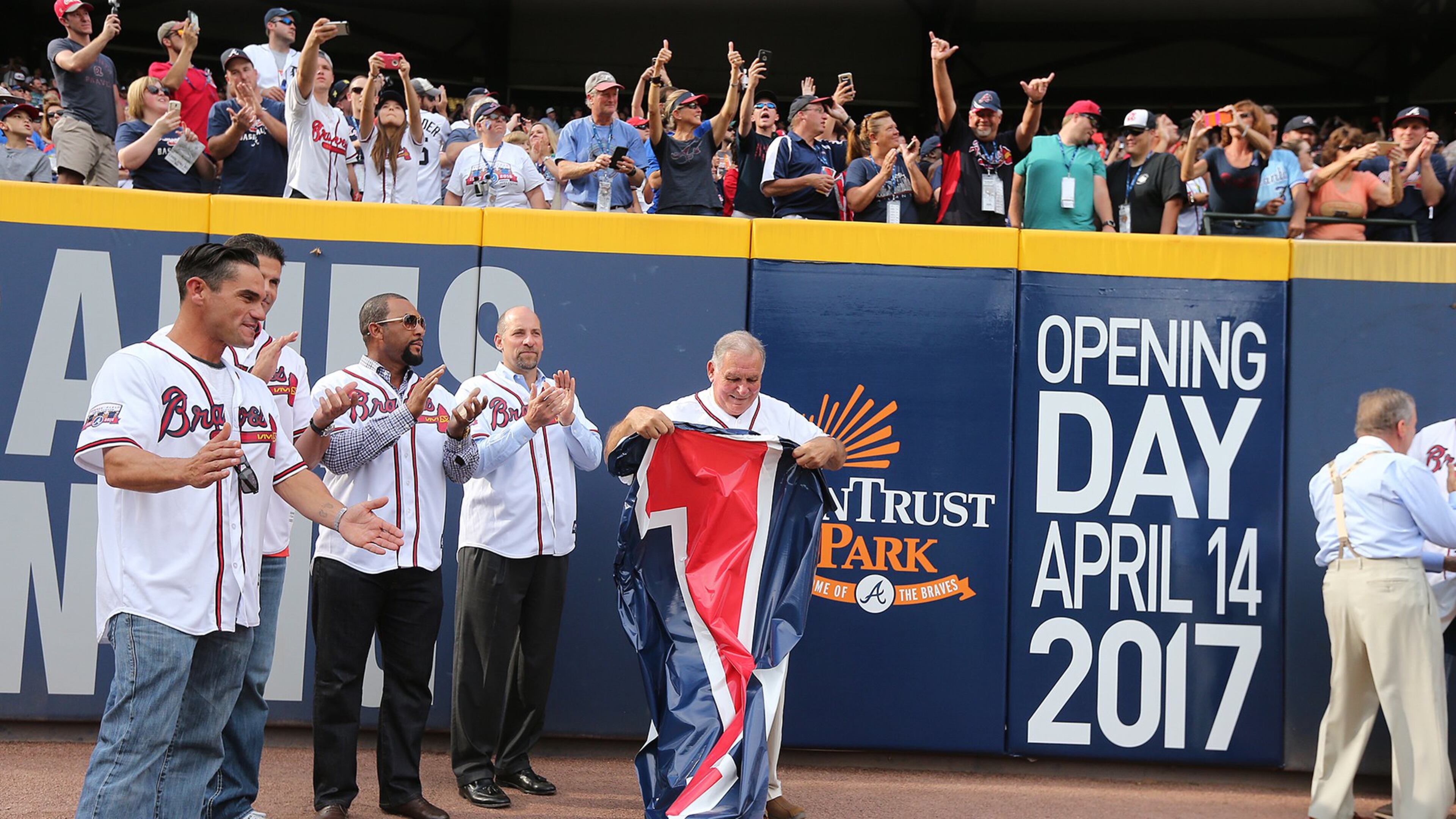 Braves Hall of Fame manager Bobby Cox, Braves vice chairman John Scherholtz (right), and former Braves players tear down the final number during the final game at Turner Field on Sunday, Oct. 2, 2016. (Curtis Compton/ccompton@ajc.com)