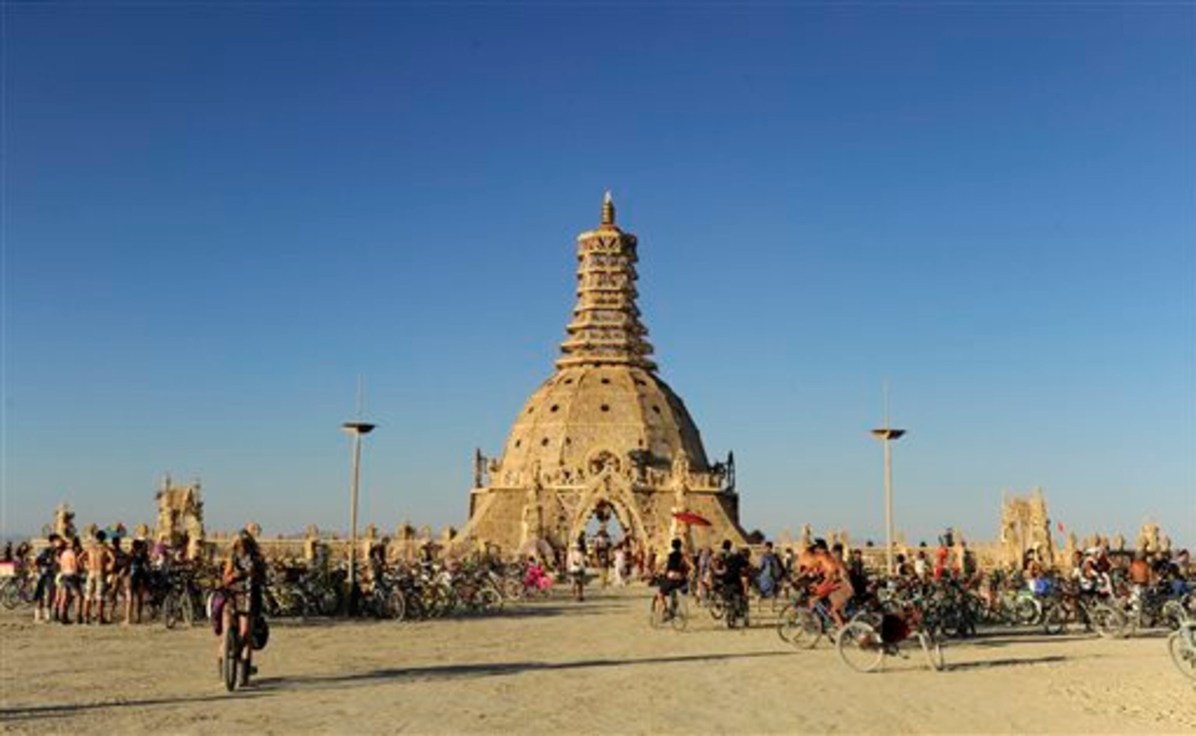In this Aug. 23, 2014 photo, Burning Man participants gather at the Temple of Grace at the annual Burning Man event on the Black Rock Desert of Gerlach, Nev. (AP Photo/The Reno Gazette-Journal, Andy Barron)