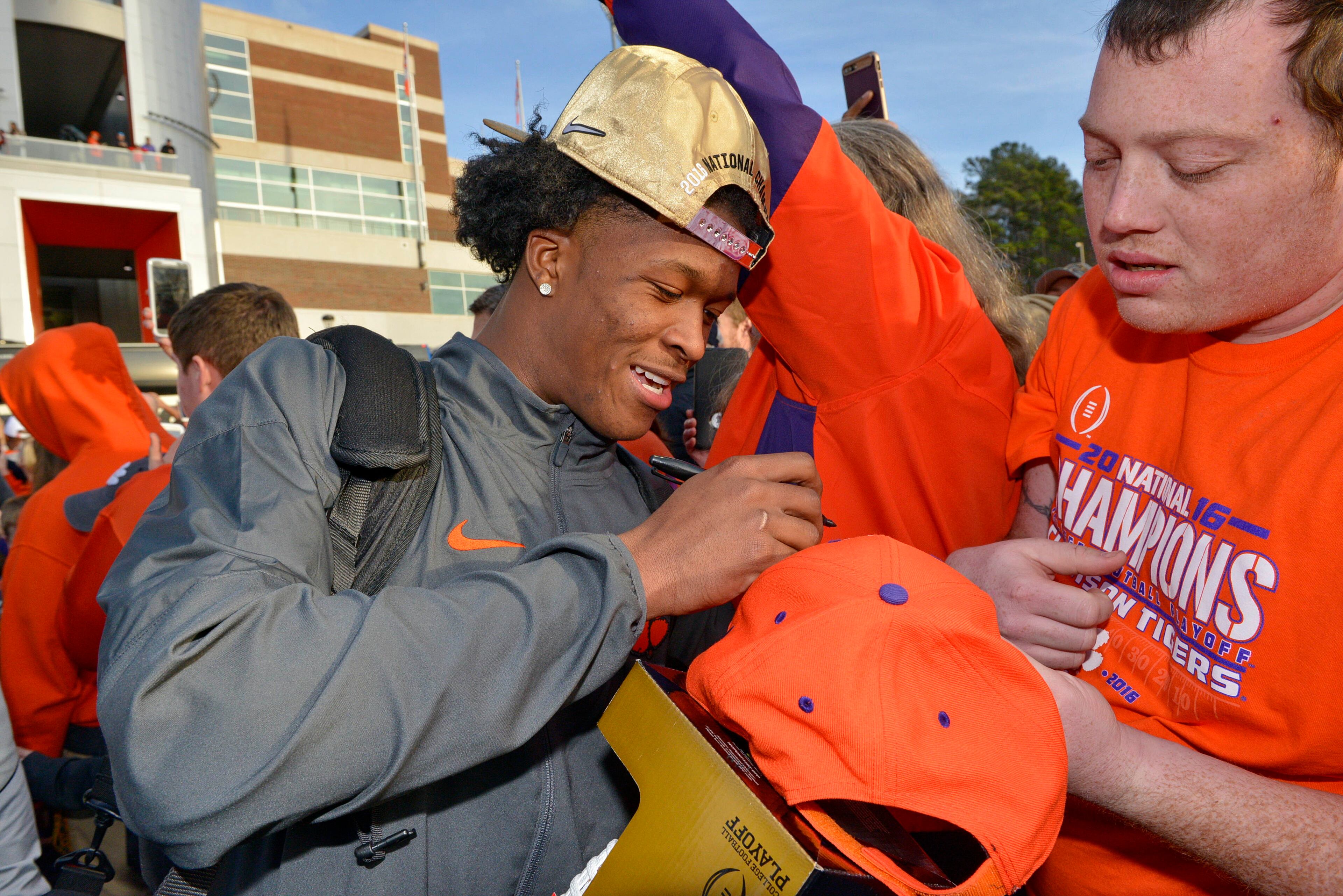 Clemson's Ray-Ray McCloud signs autographs for fans Tuesday, Jan. 10, 2017, in Clemson, S.C., the day after the Tigers defeated Alabama 35-31 in the College Football Playoff championship NCAA college football game in Tampa. (AP Photo/Richard Shiro)