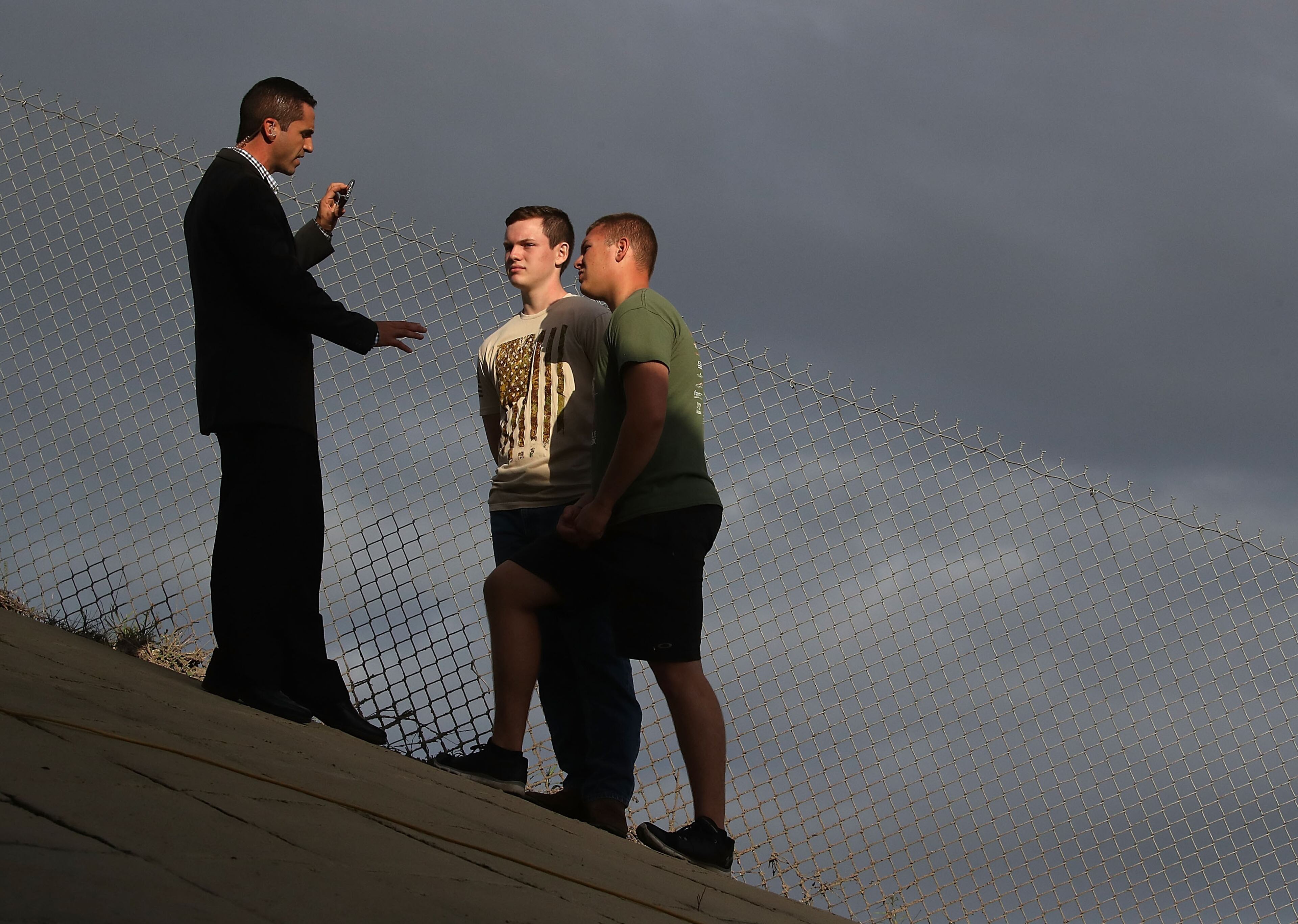 PARKLAND, FL - FEBRUARY 15: People talk under a overpass at a police check point near the Marjory Stoneman Douglas High School where 17 people were killed by a gunman yesterday, on February 15, 2018 in Parkland, Florida. Police arrested the suspect after a short manhunt, and have identified him as 19 year old former student Nikolas Cruz. (Photo by Mark Wilson/Getty Images)