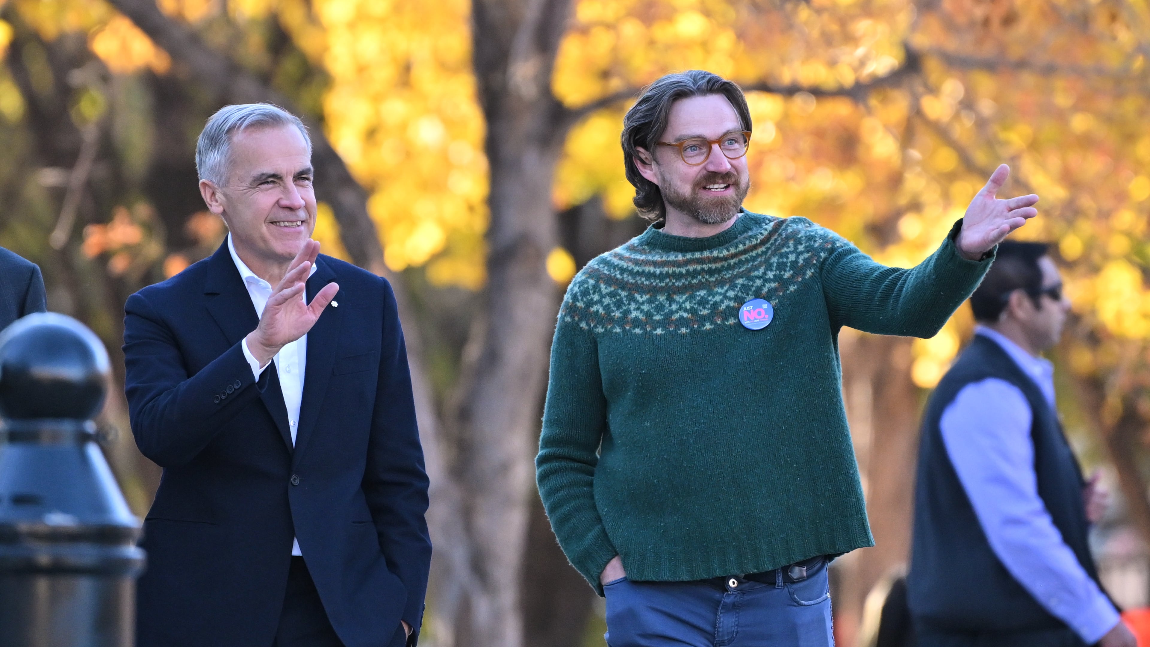Prime Minister Mark Carney, left, arrives with Executive Director of Public Interest Alberta Brad Lafortune to meet volunteers at Bridgeland Riverside Community Association Park in Calgary, Alberta, on Thursday Oct. 15, 2026. (Mike Sturk/The Canadian Press via AP)
