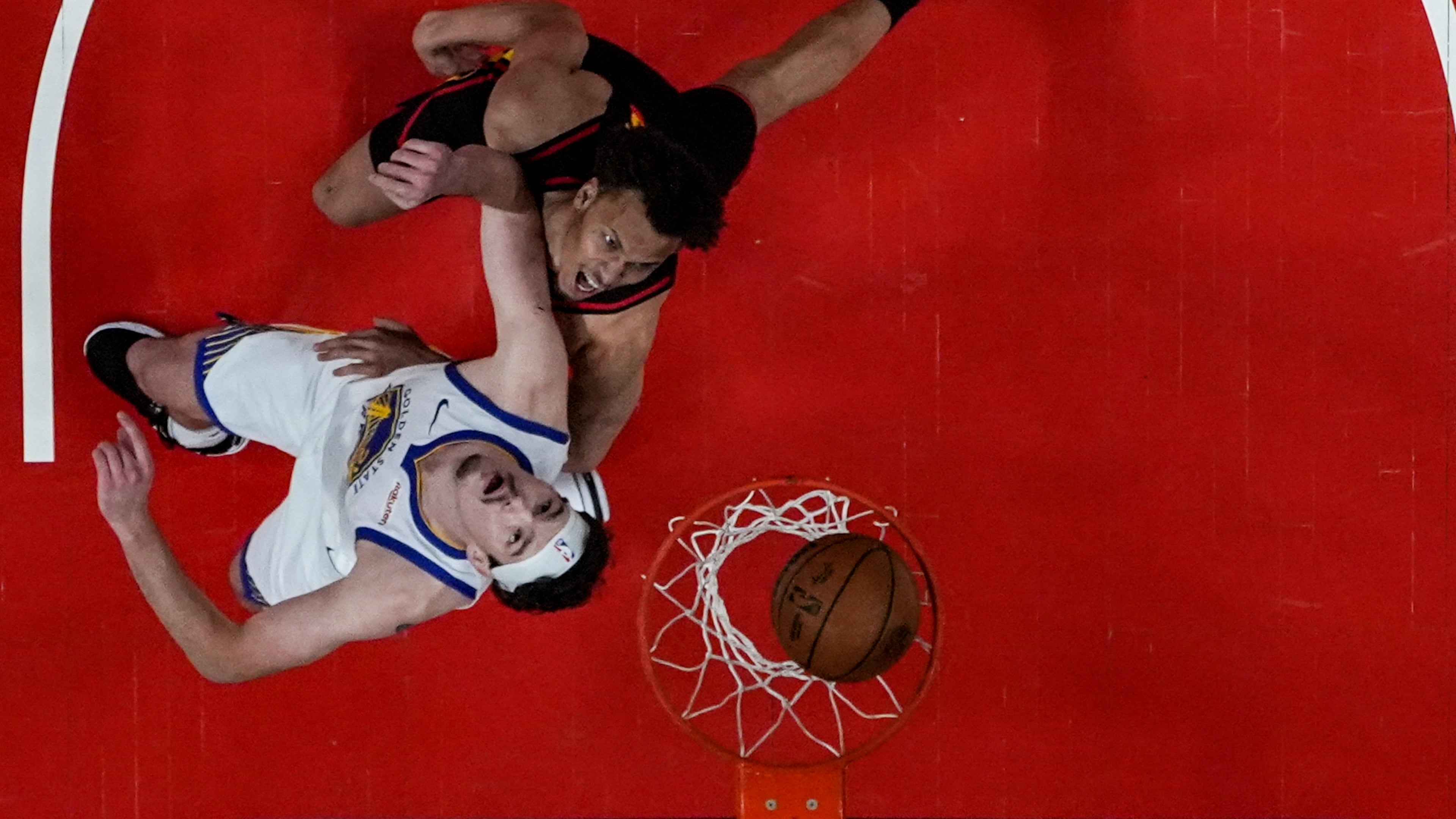 Atlanta Hawks guard Dyson Daniels (5) shoots against Golden State Warriors center Quinten Post (21) during the first half of an NBA basketball game, Saturday, March 21, 2026, in Atlanta. (AP Photo/Mike Stewart)