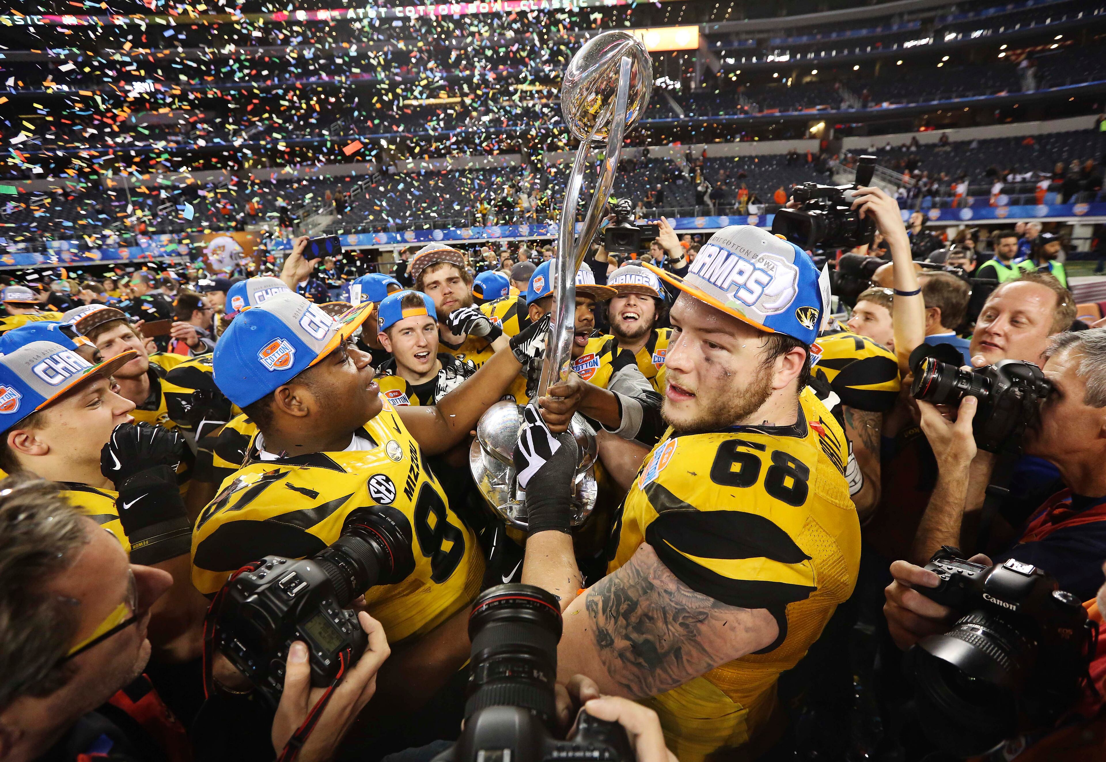 Jan 3, 2014; Arlington, TX, USA; Missouri Tigers defensive lineman Nate Crawford (87) and offensive linesman Justin Britt (68) celebrate with the Cotton Bowl trophy after the victory against the Oklahoma State Cowboys in the 2014 Cotton Bowl at AT&T Stadium.